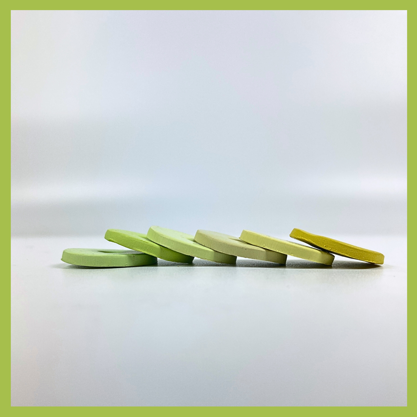 A graceful slide of Spring Green Polymer Clay Palette sample color discs