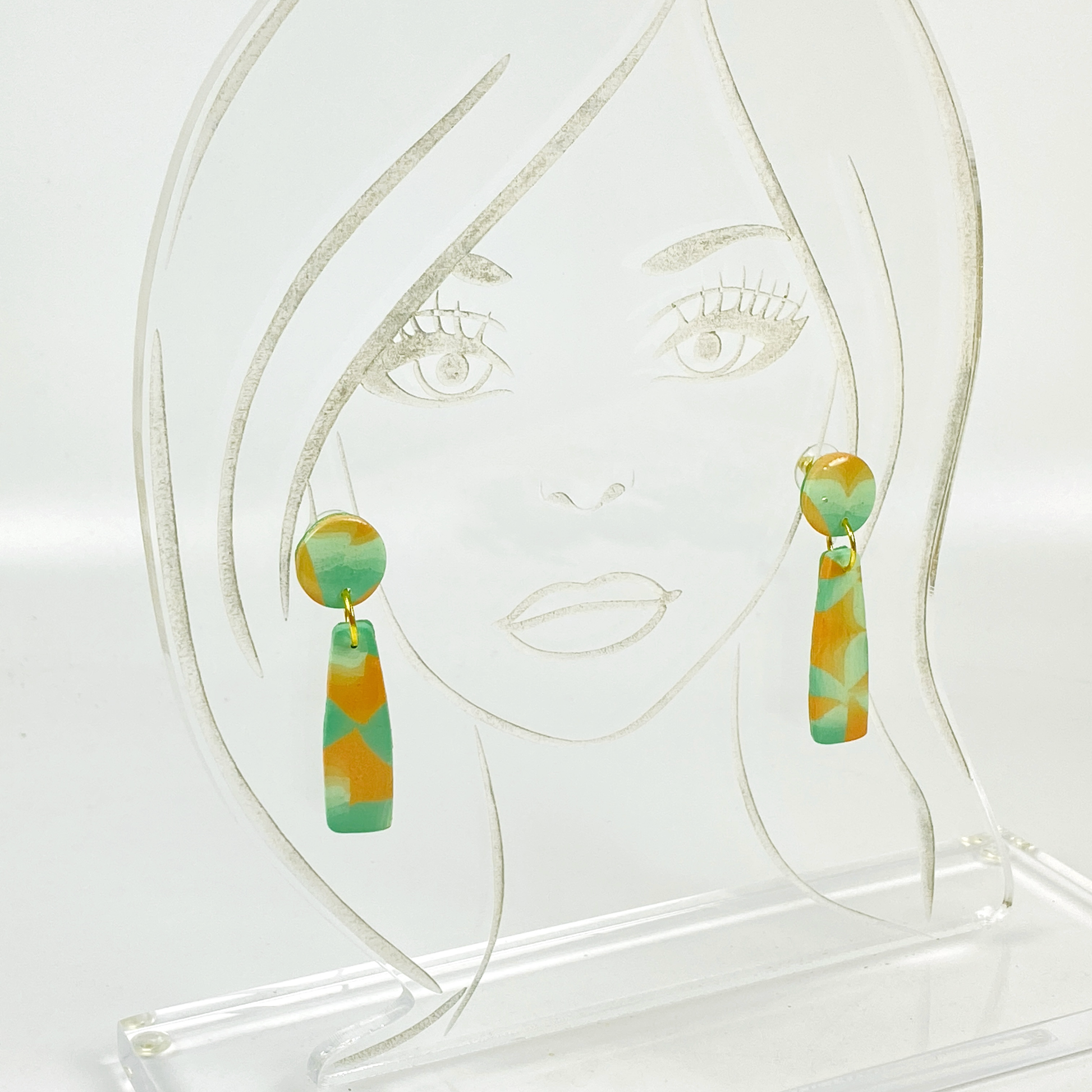 Desert Dangle Earrings on an acrylic display head.
