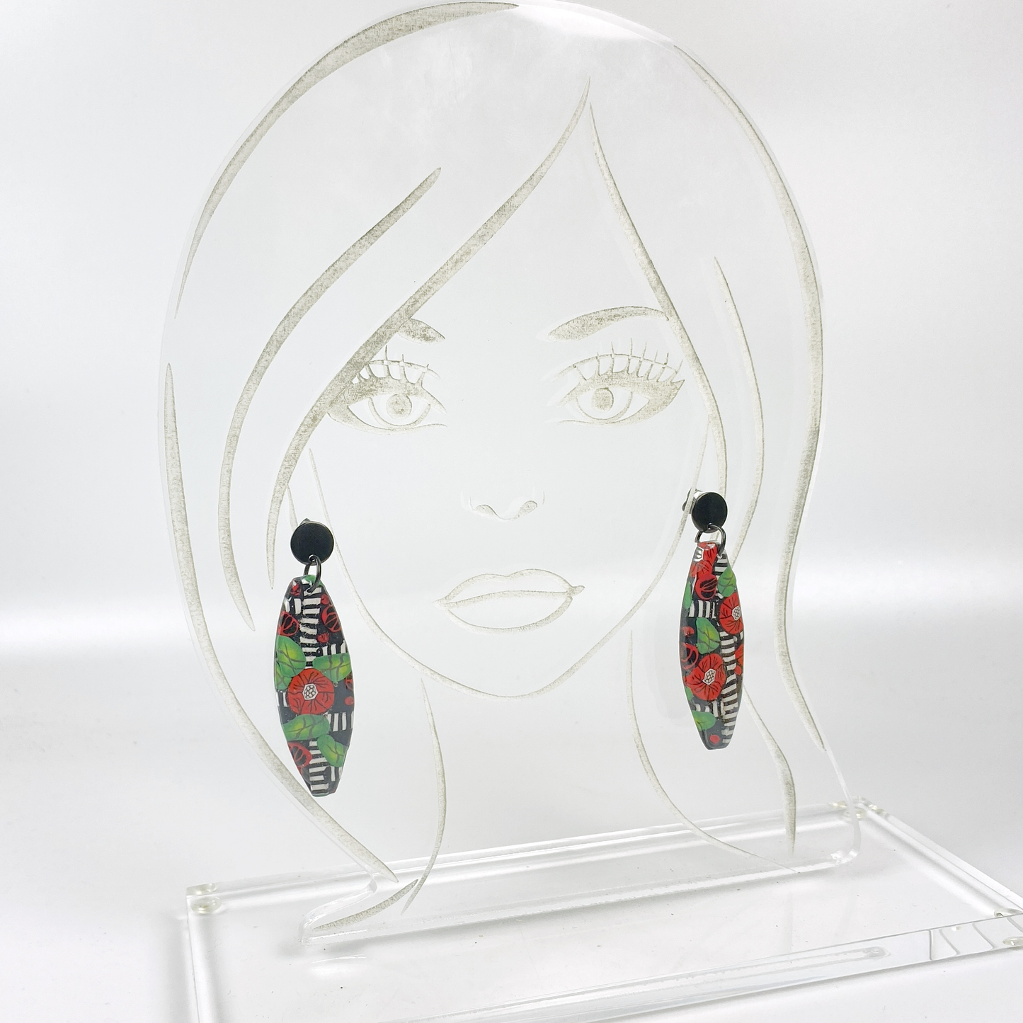 Red Lattice Rose Handmade Polymer Clay Earrings on an acrylic display head