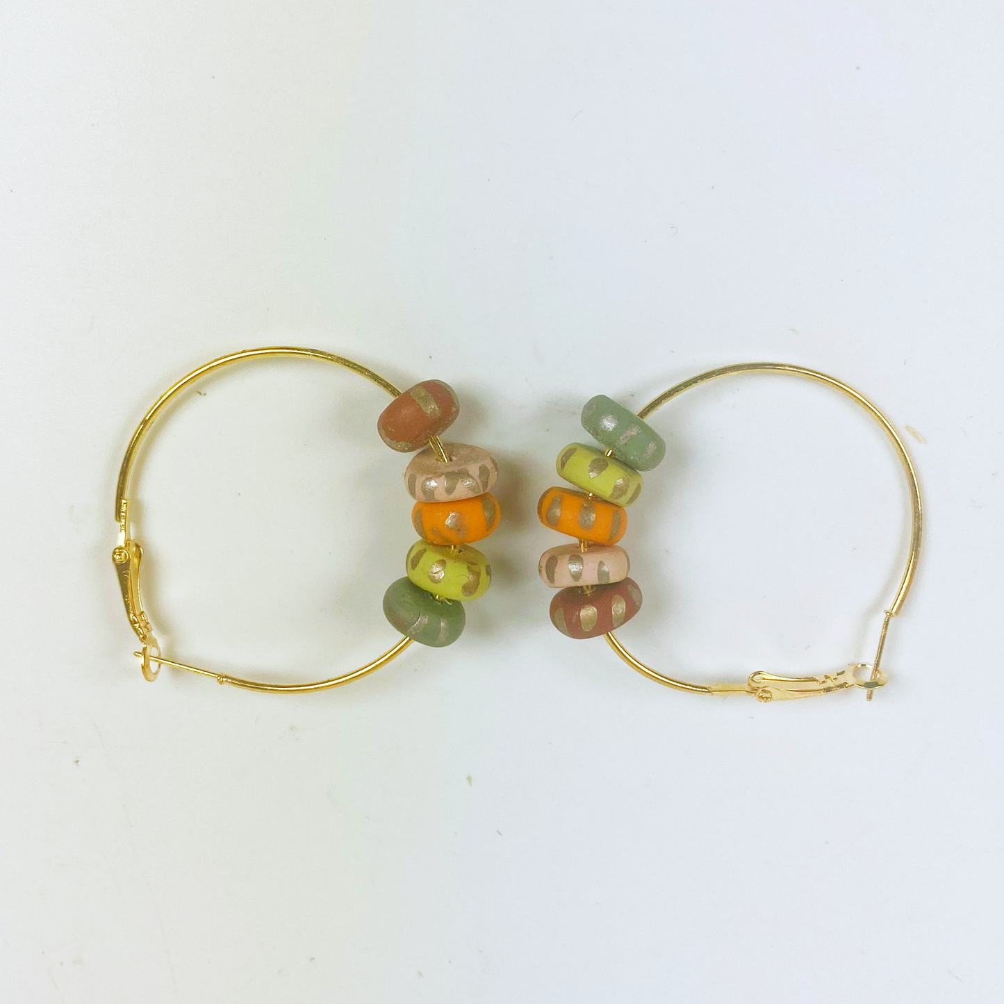 Handmade Polymer Clay Hoop Earrings with Autumn Beads on neutral background