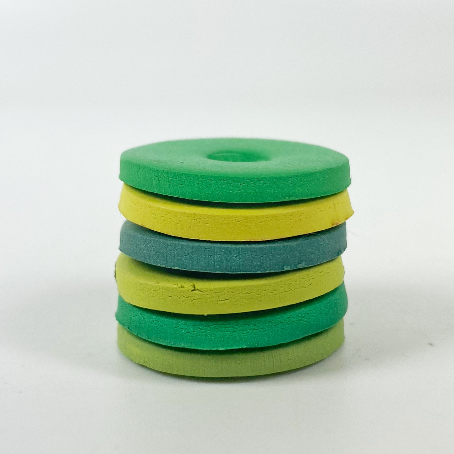 St. Patrick's Day Palette Polymer Clay Color Mixing Tutorial sample color discs in a stack.