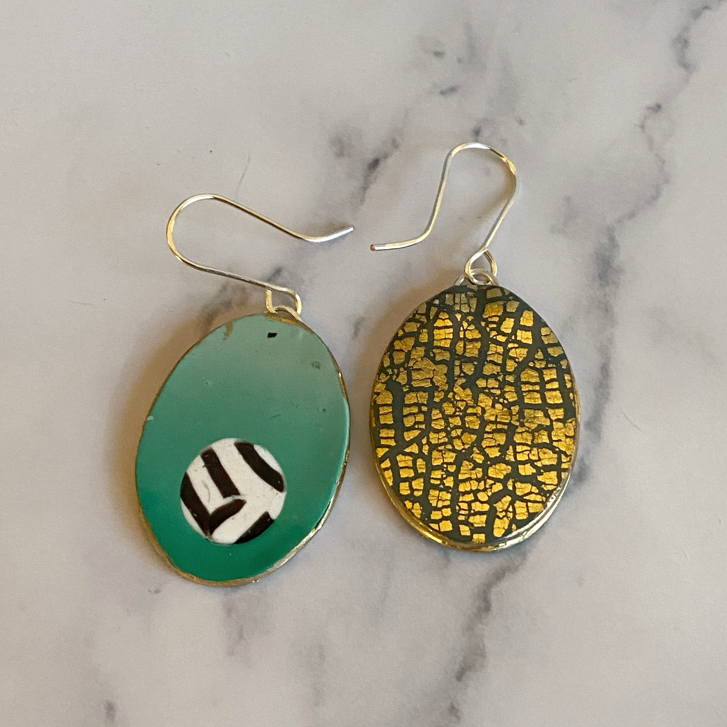 Showing the front of one earring and the back of the other