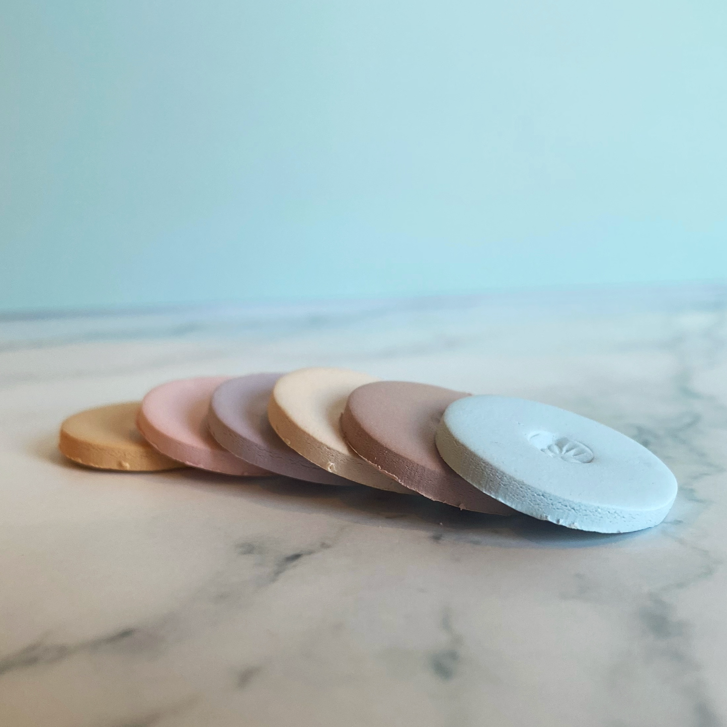 The six sample clay color discs shown in a cascade!