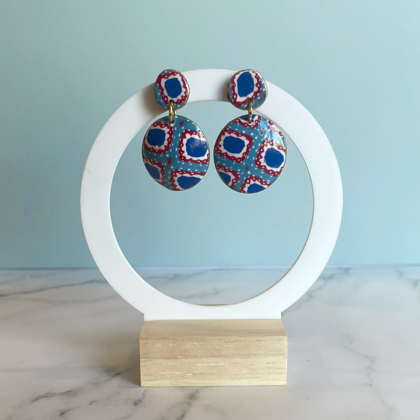 Handmade Polymer Clay Bandana Dangle Earrings on a white display stand