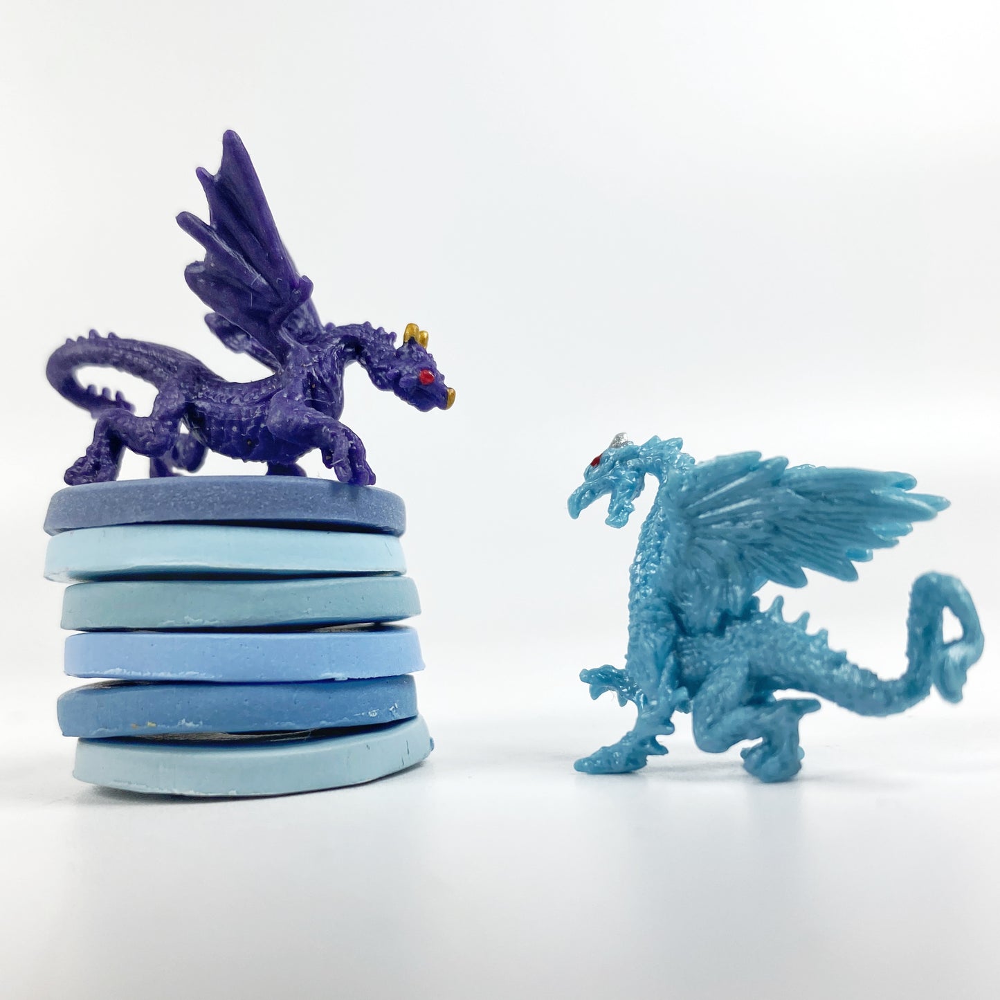 Lake Waters polymer clay color palette stack of sample clay disks with two mini dragons, deep blue and light blue