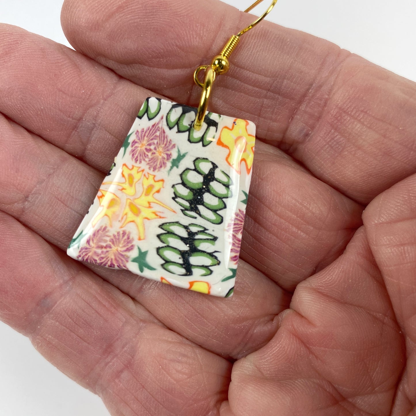 Blossom Burst Handmade Polymer Clay Dangle Earrings handheld for size reference