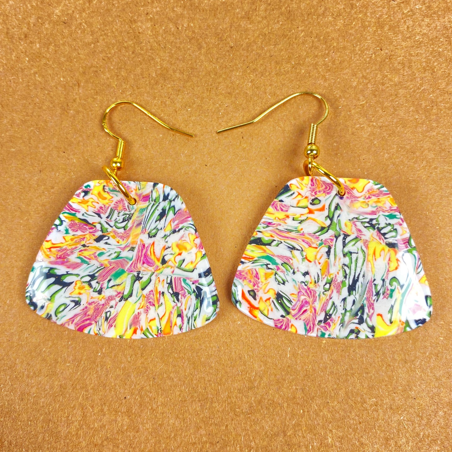 Garden Marbled Handmade Polymer Clay Dangle Earrings front view on warm brown background