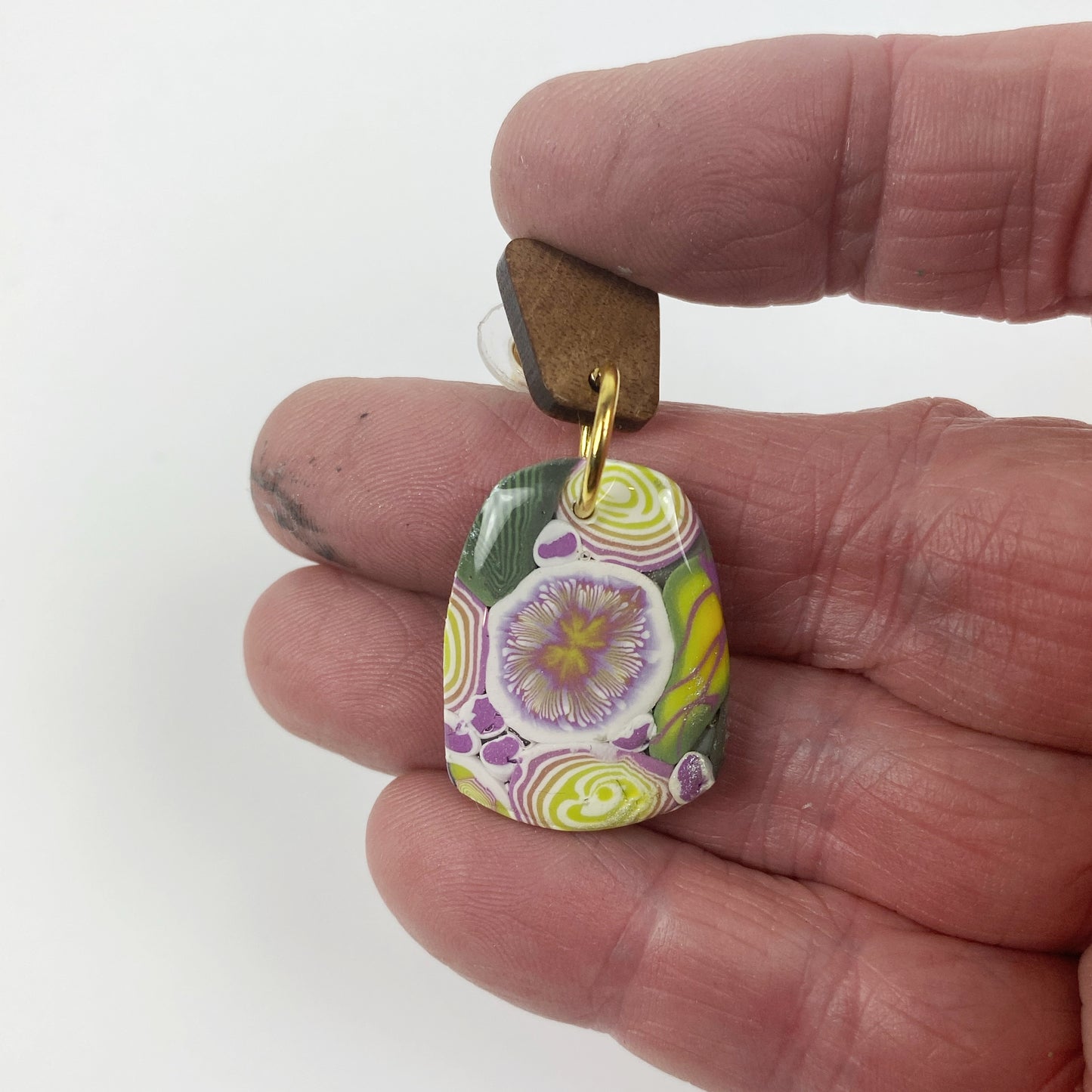 Green Floral Handmade Polymer Clay Dangle Earrings handheld for size reference