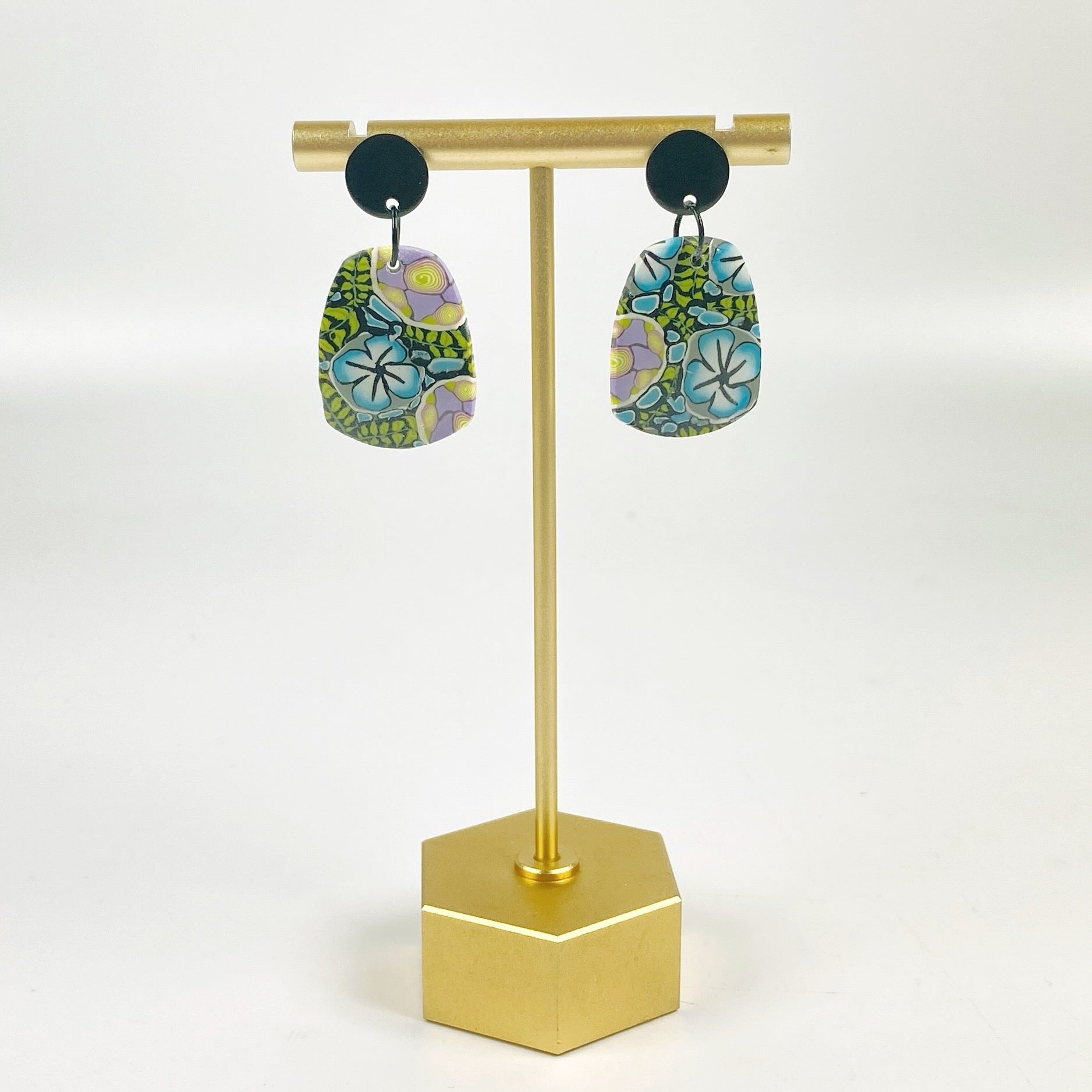 Twilight Blooms Earrings on a brass earring stand