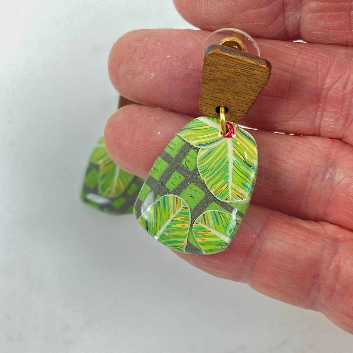 Jungle Canopy Handmade Polymer Clay Dangle Earrings handheld for size reference