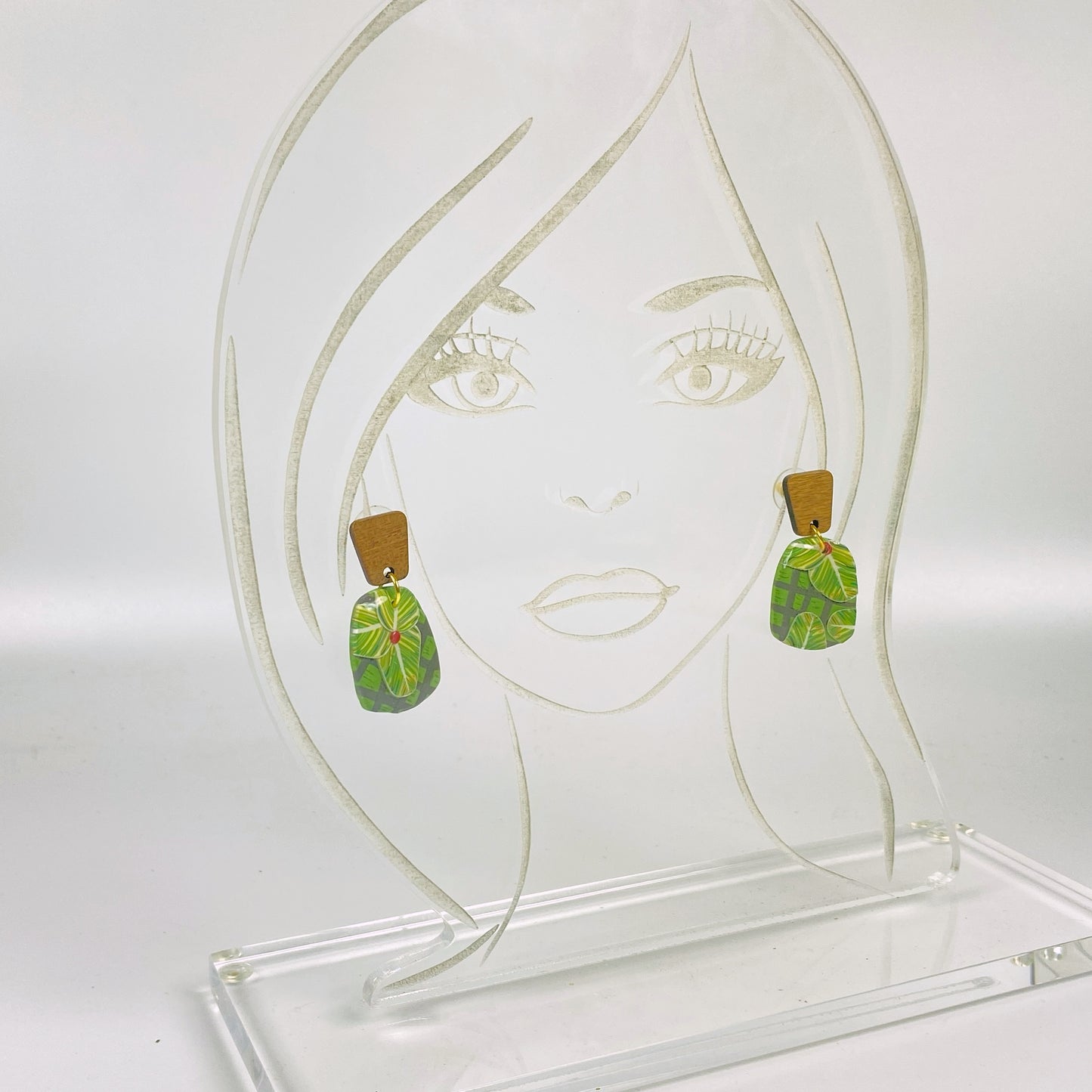 Jungle Canopy Handmade Polymer Clay Dangle Earrings on an acrylic display head