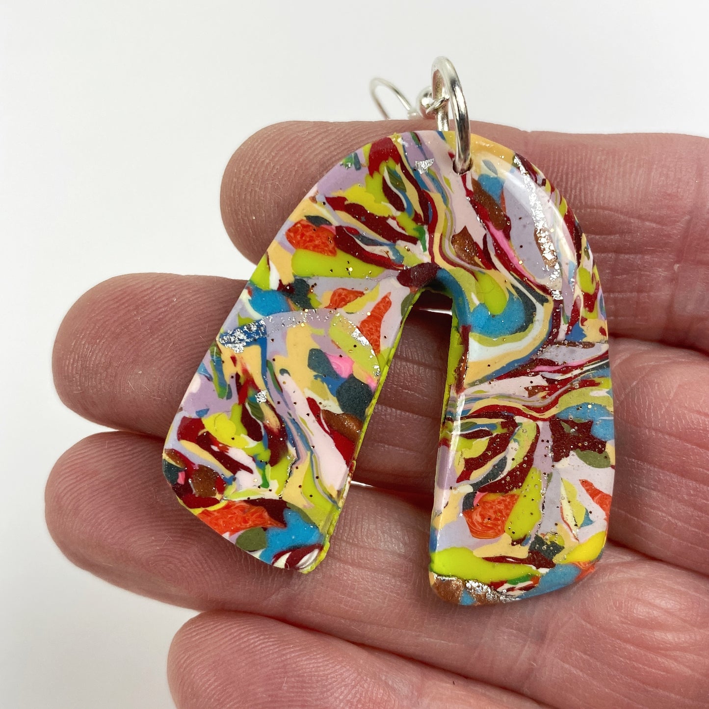 Meadow Breeze Rainbow Handmade Polymer Clay Dangle Earrings handheld for size reference