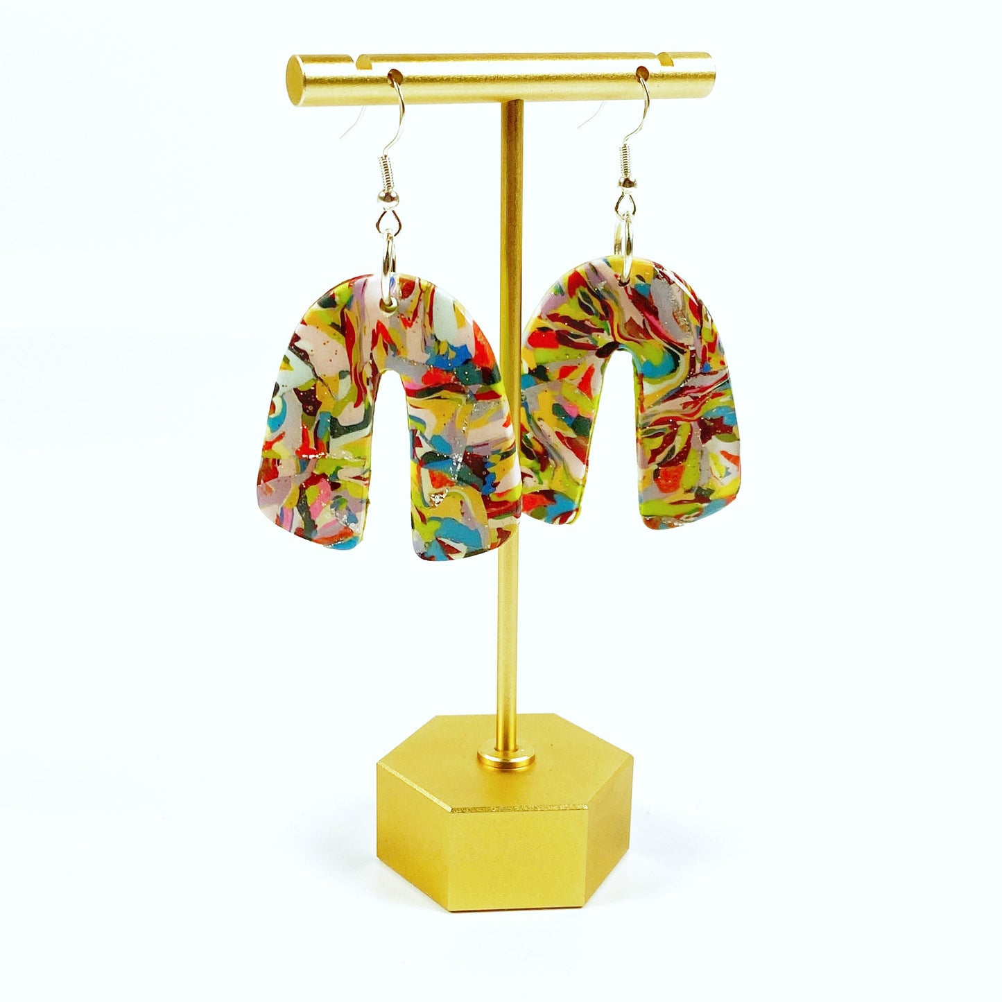 Meadow Breeze Rainbow Handmade Polymer Clay Dangle Earrings on brass earring display stand