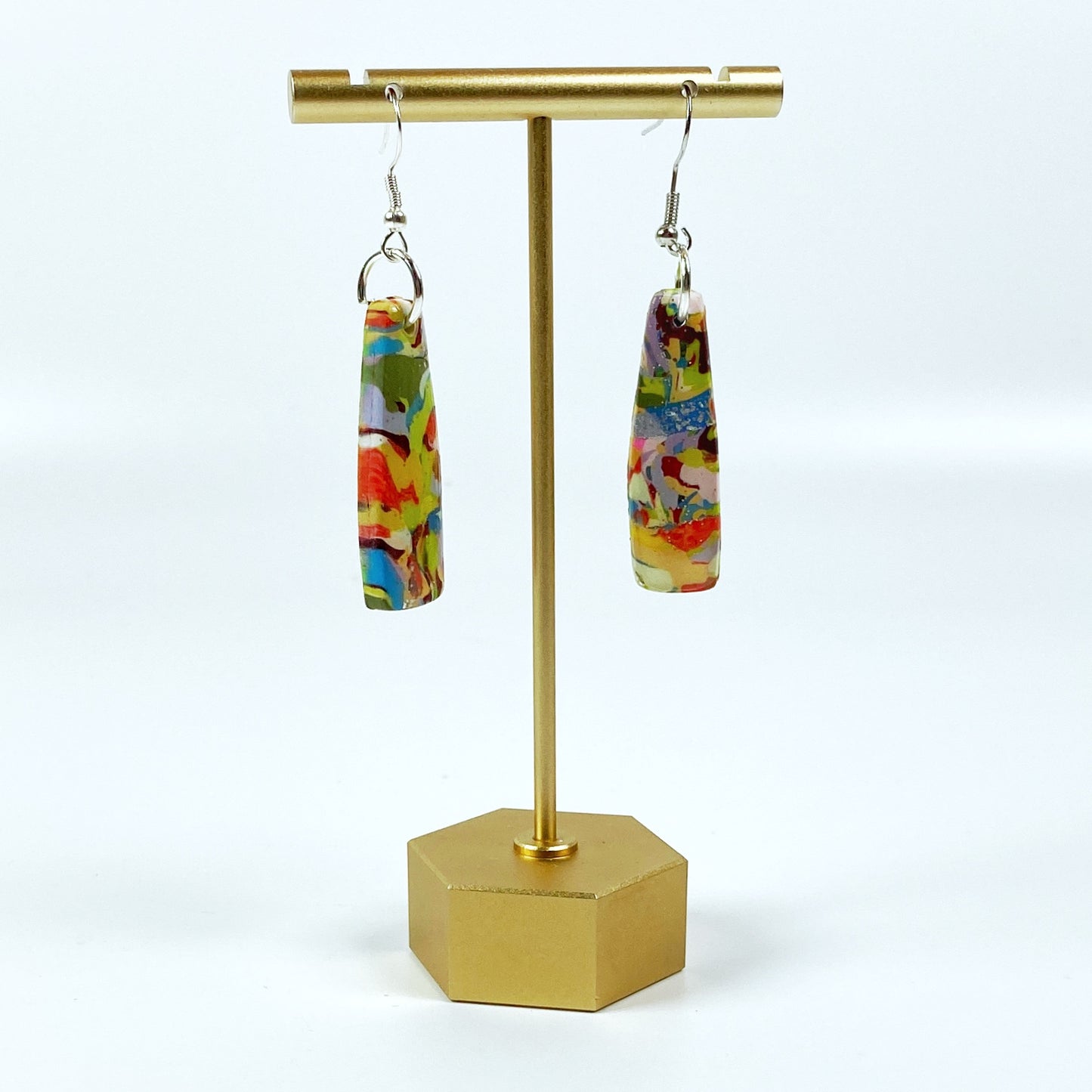 Meadow Breeze Polymer Clay Handmade Dangle Earrings on brass earring display stand