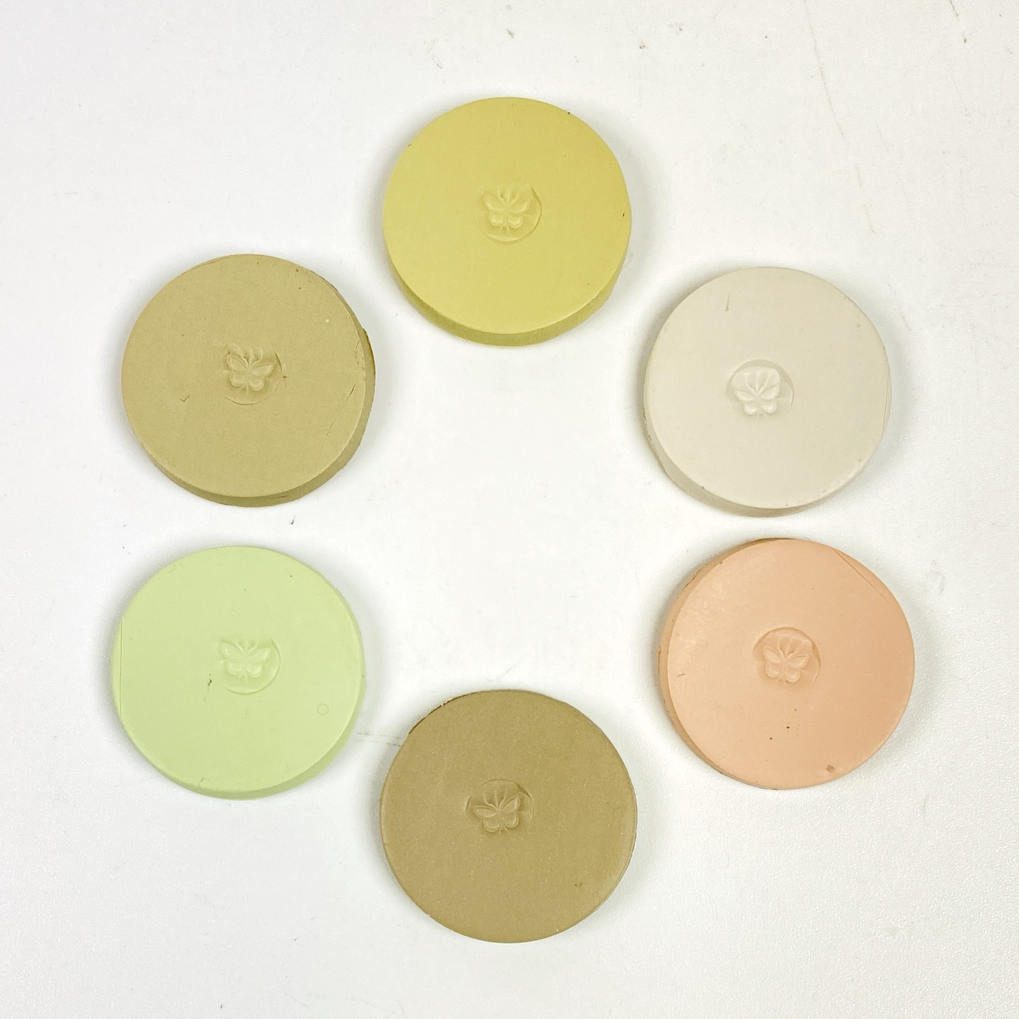 Discs of Polymer Clay in all 6 farmhouse colors of this palette, arranged in a ring.