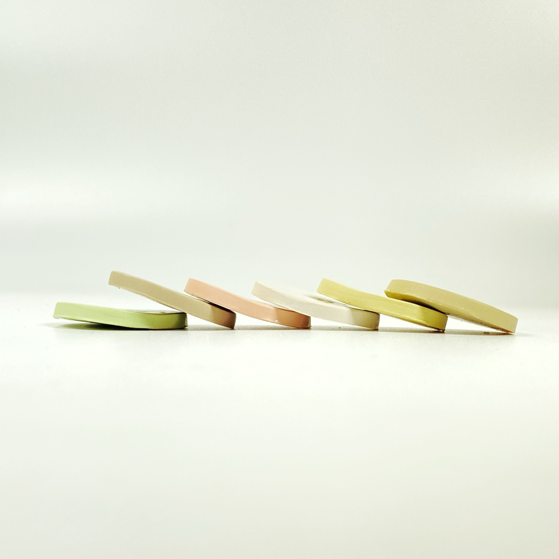 The 6 polymer clay colors of Farmhouse Palette shown in sample discs stacked in a cascade.