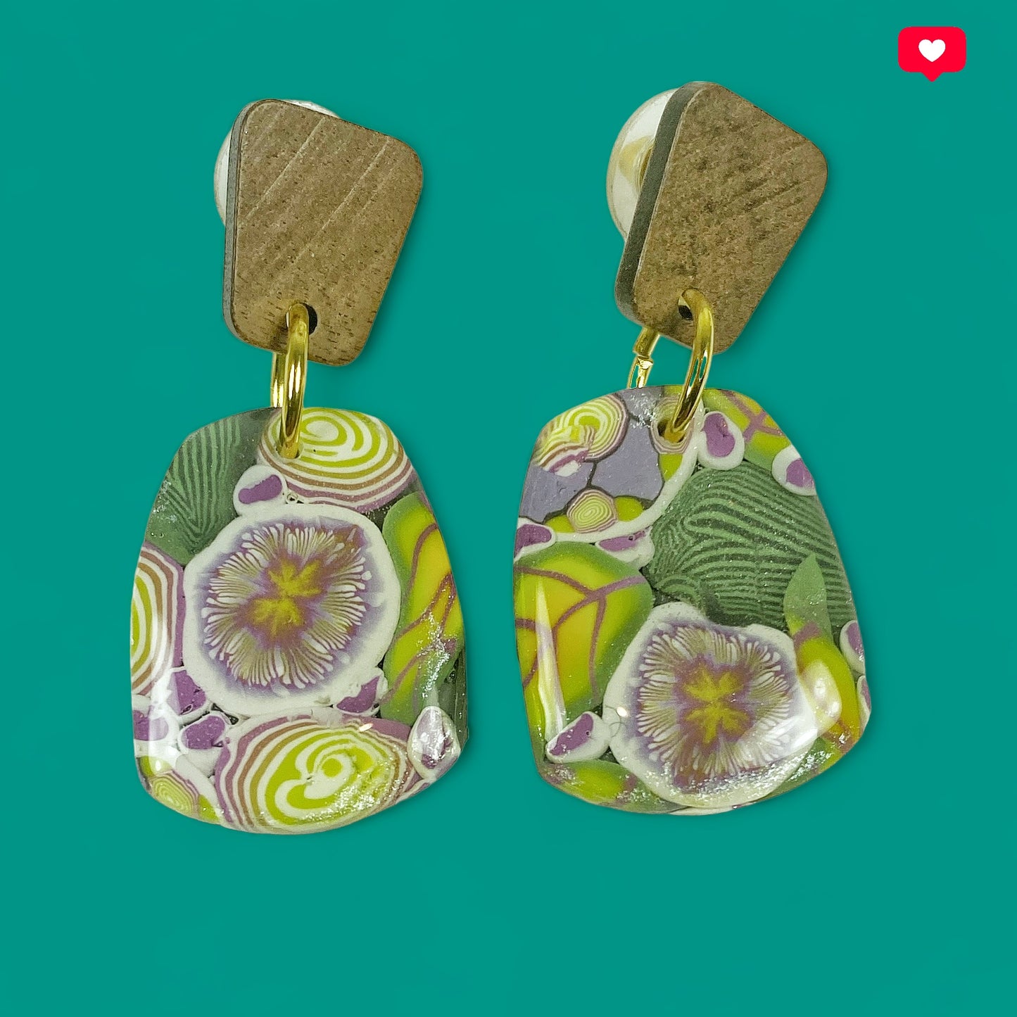 Green Floral Handmade Polymer Clay Dangle Earrings on a teal background