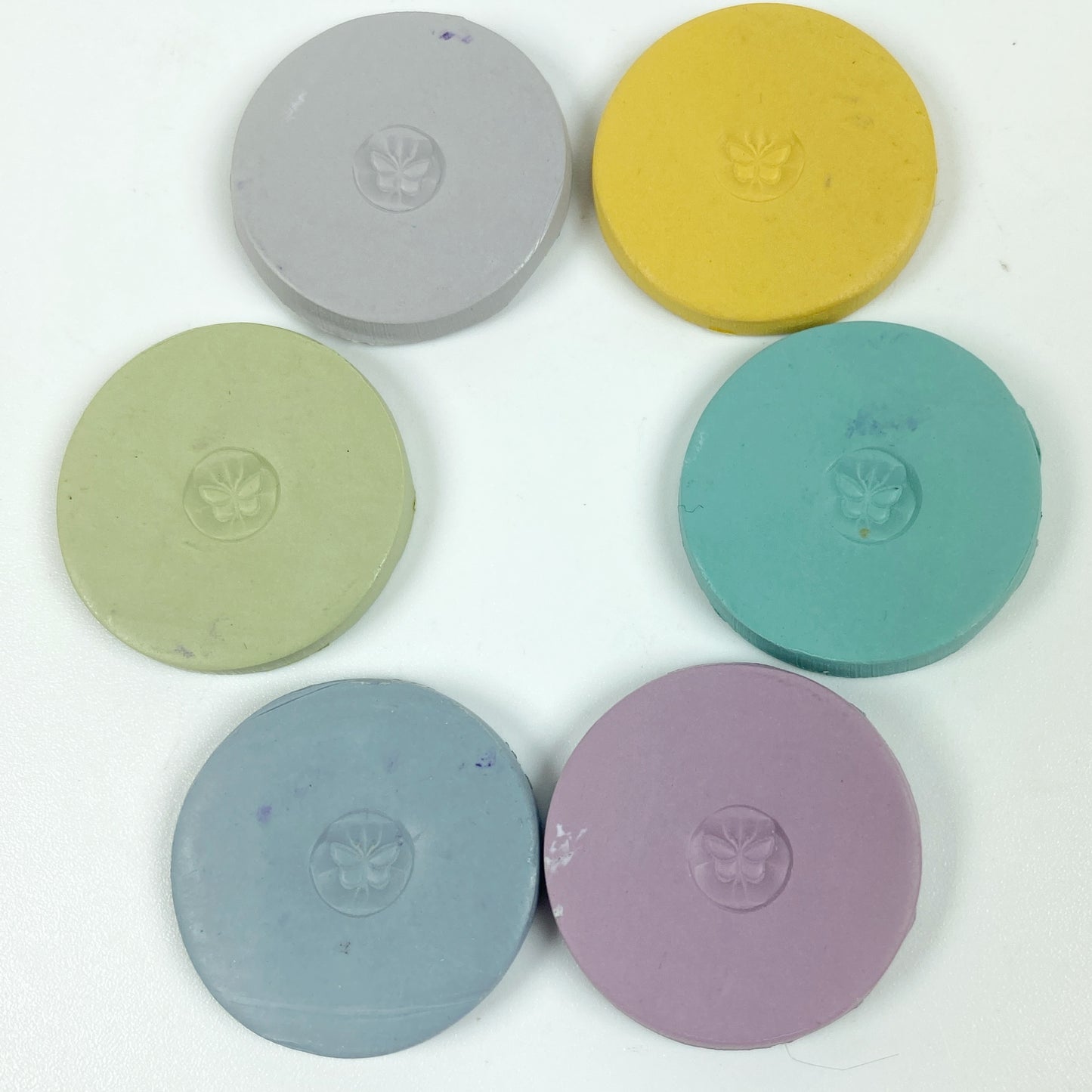 Discs of Polymer Clay in all 6 Heirloom colors of this palette, arranged in a ring.