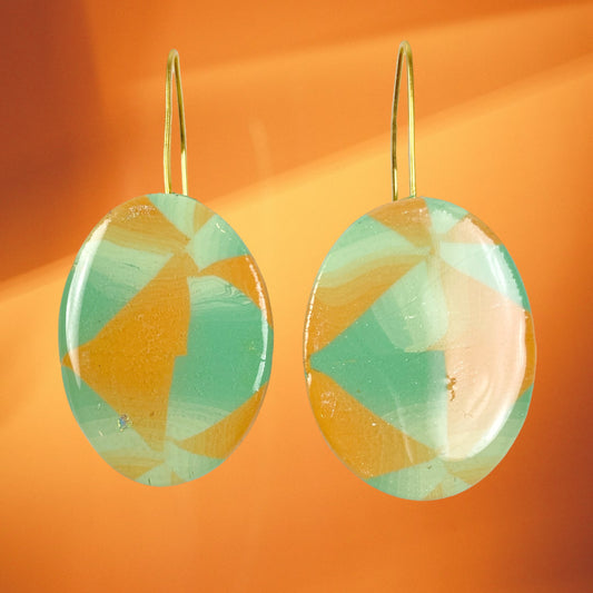 Sage & Terracotta Handmade Polymer Clay Dangle Earrings on gradient orange background