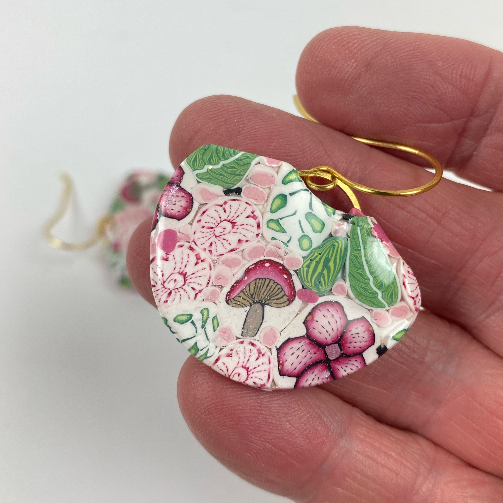 Pink Woodlands Handmade Polymer Clay Dangle Earrings handheld for size reference