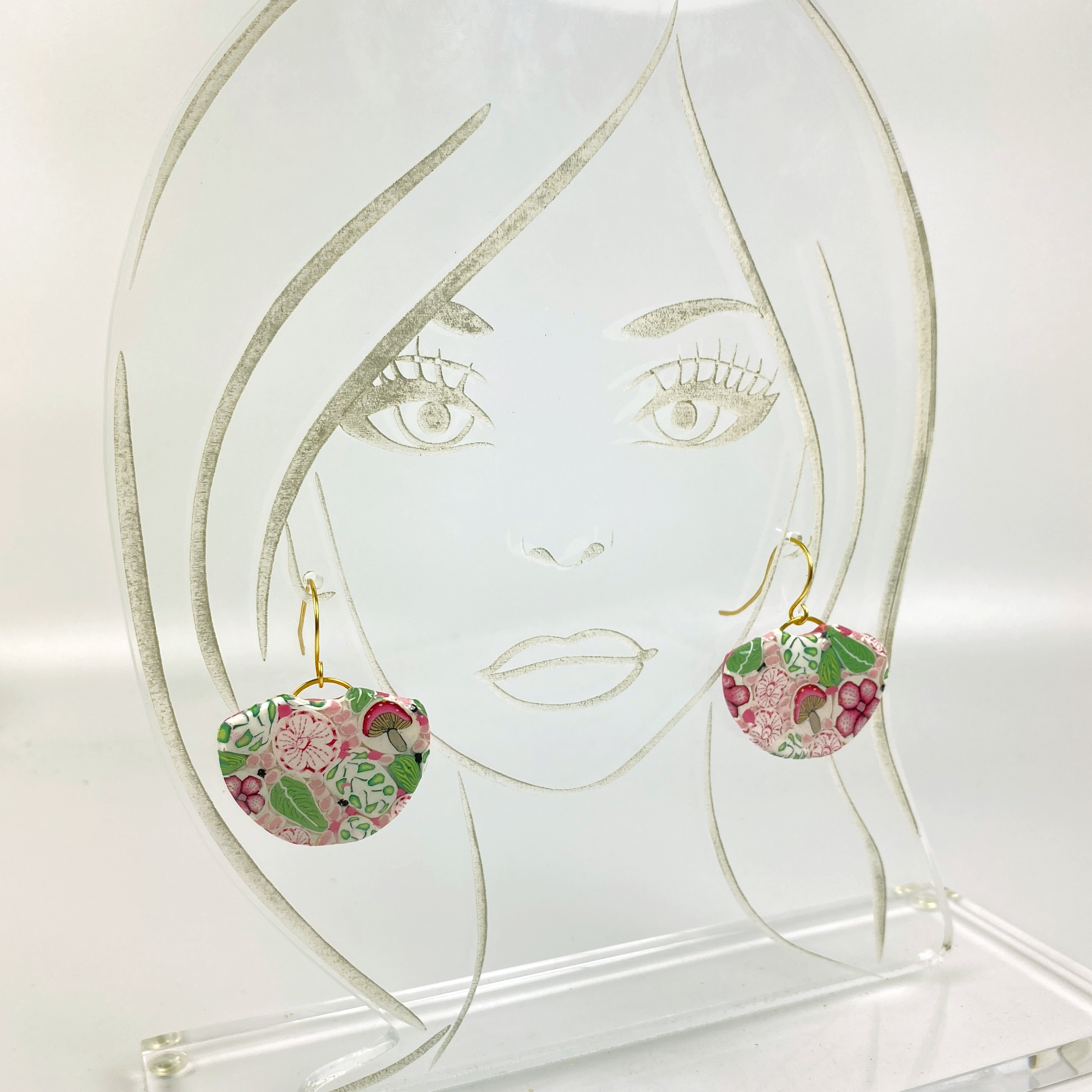 Pink Woodlands Handmade Polymer Clay Dangle Earrings shown on an acrylic display head