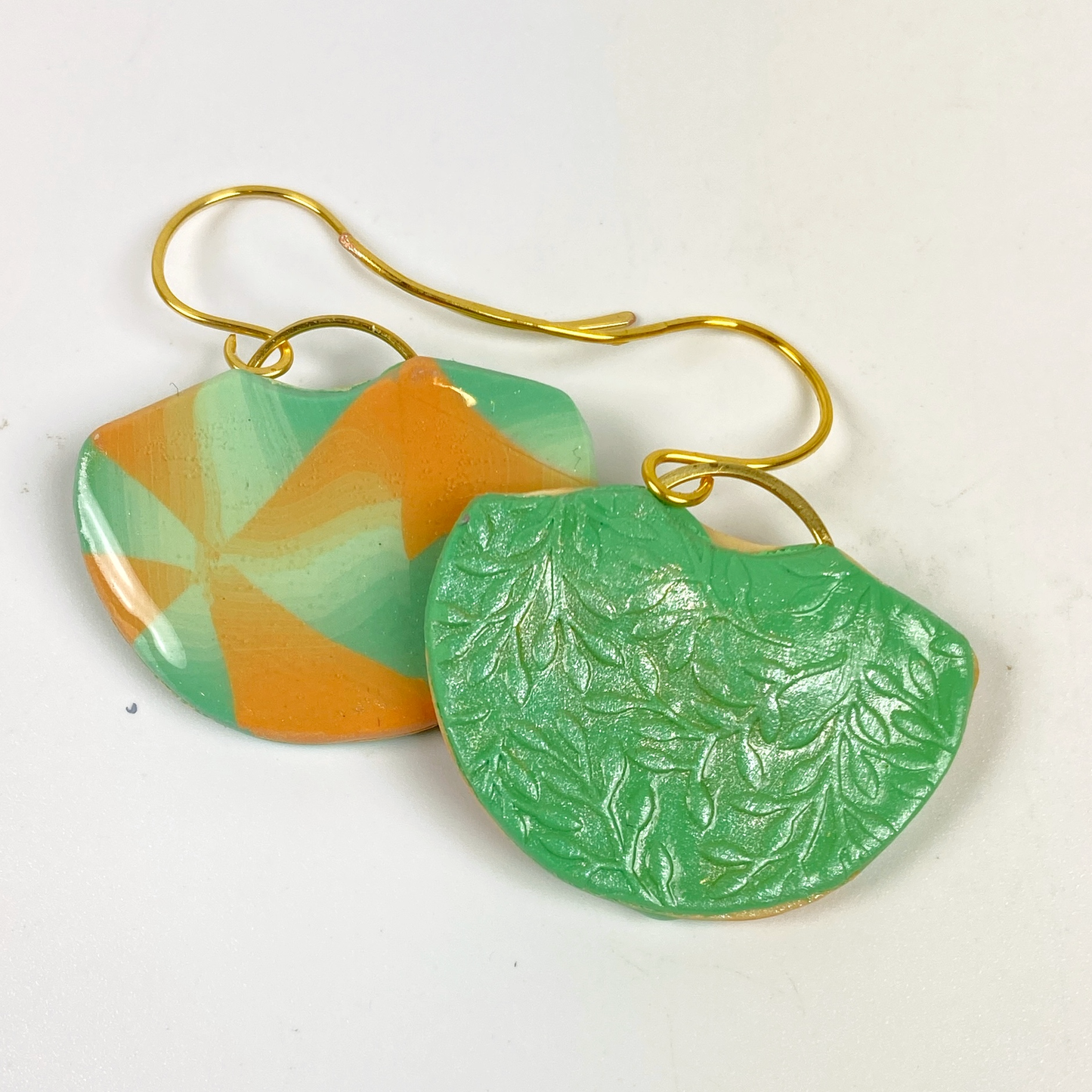 Desert Fan Handmade Polymer Clay Earrings showing the embossed green back of one earring
