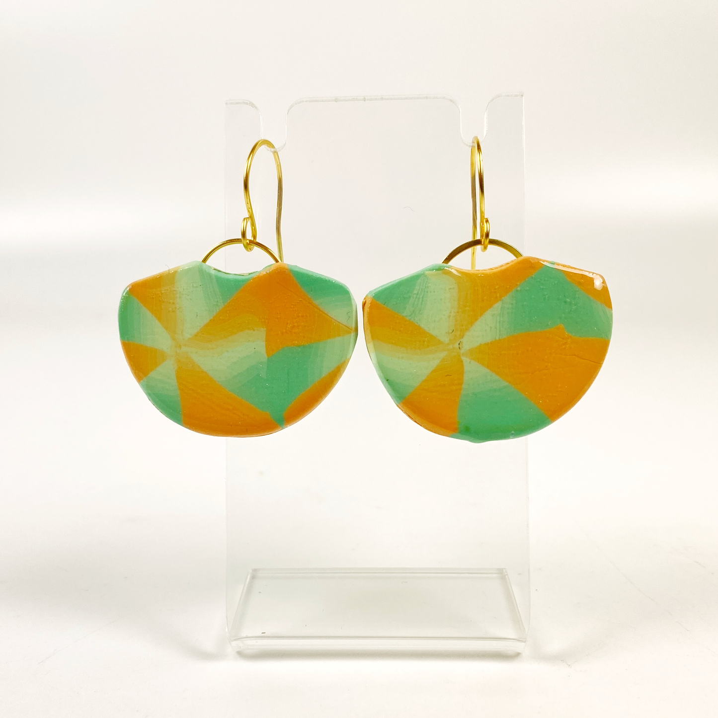 Desert Fan Handmade Polymer Clay Earrings on a small acrylic display stand