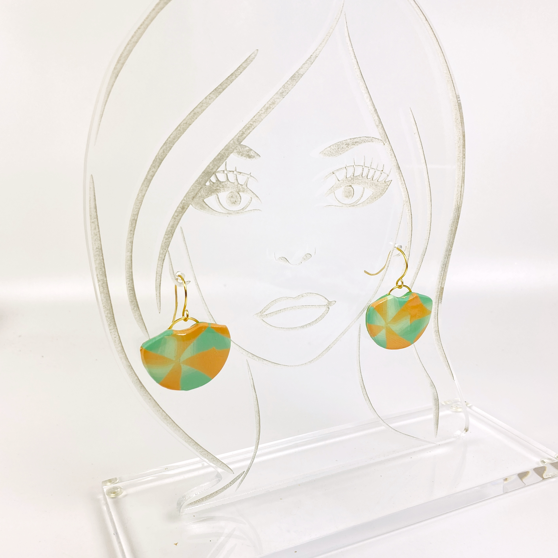 Desert Fan Handmade Polymer Clay Earrings on an acrylic display stand