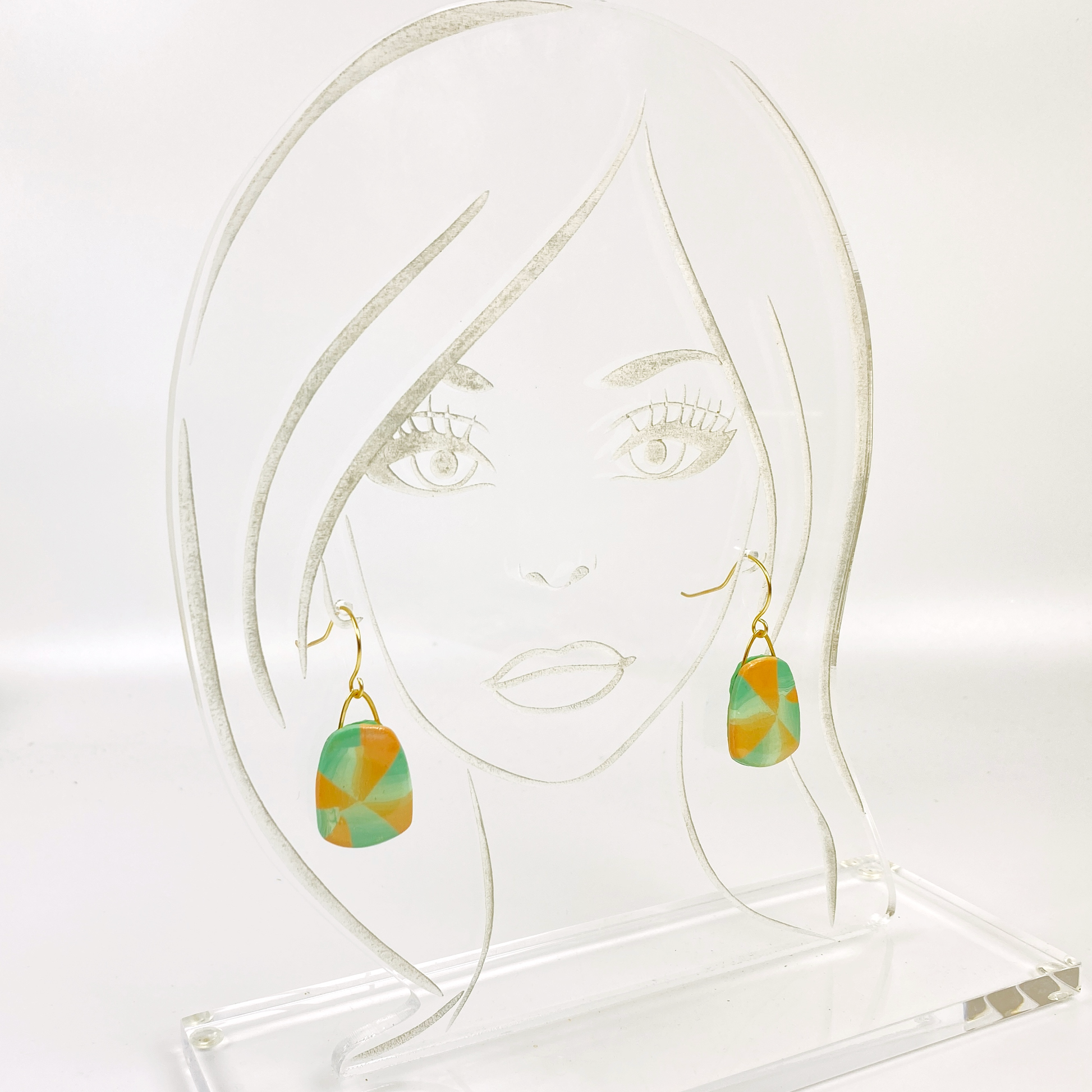 Desert Trapezoid Handmade Polymer Clay Earrings on an acrylic display head