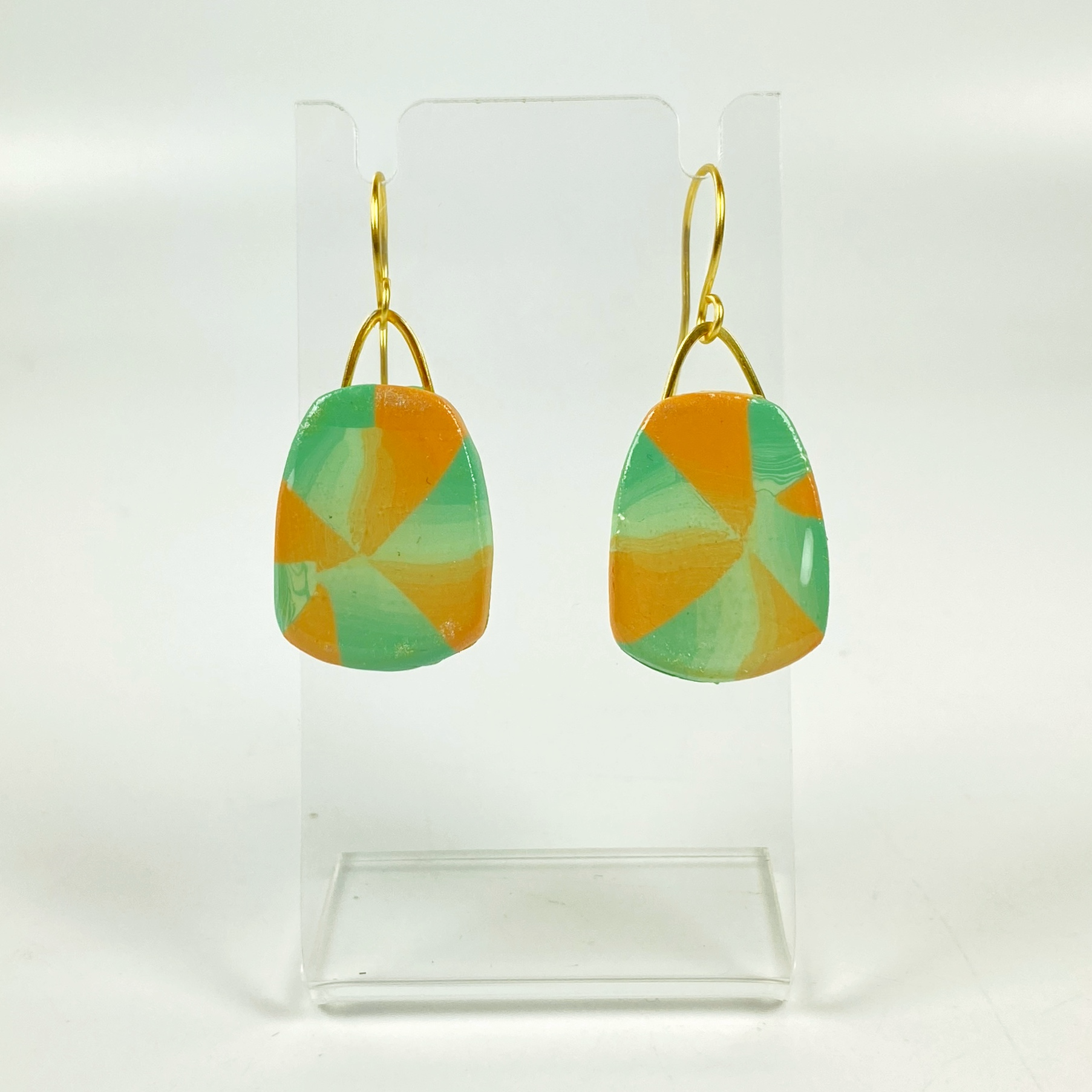 Desert Trapezoid Handmade Polymer Clay Earrings on a small acrylic stand
