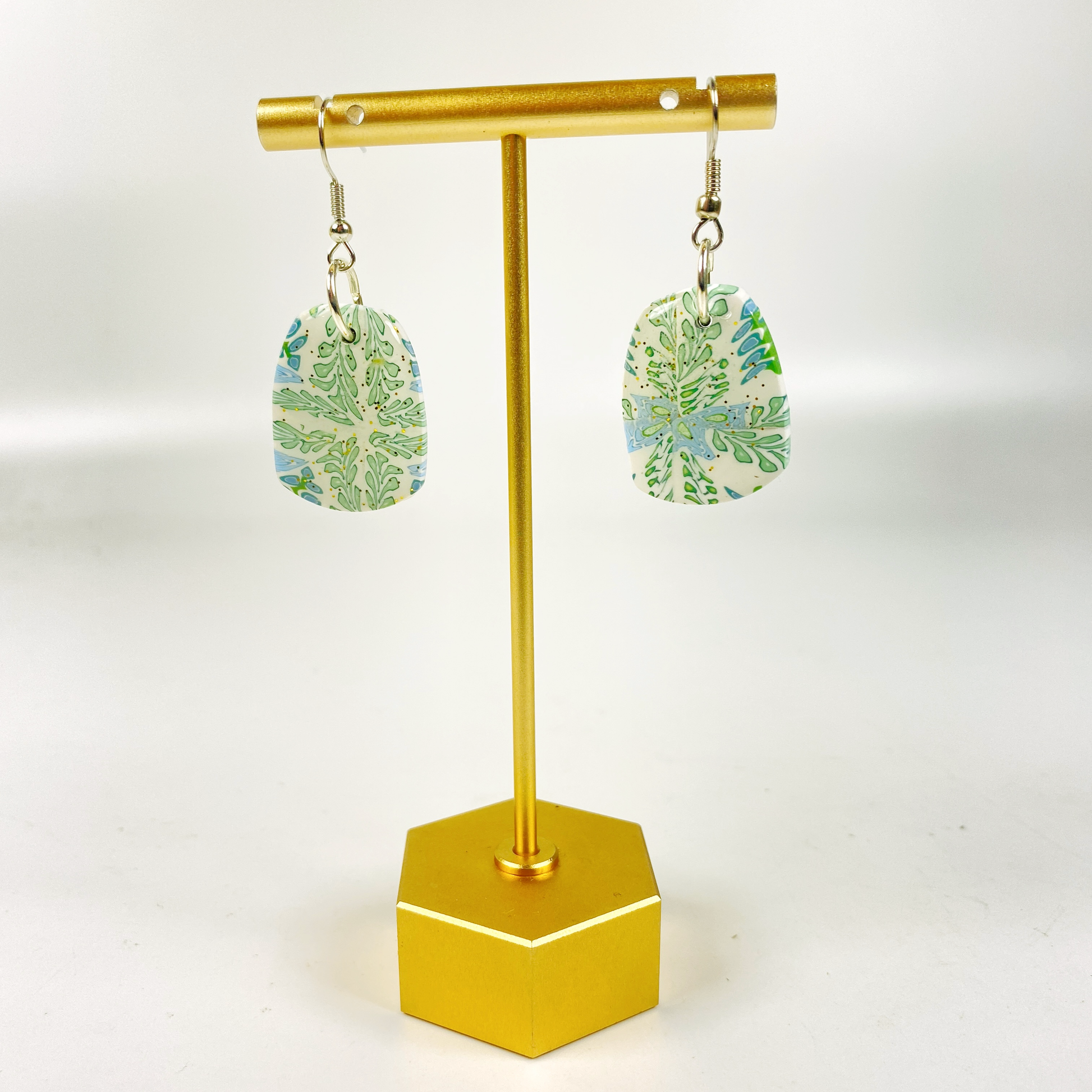 Blue Blossom Handmade Polymer Clay Pendent Earrings on brass display stand