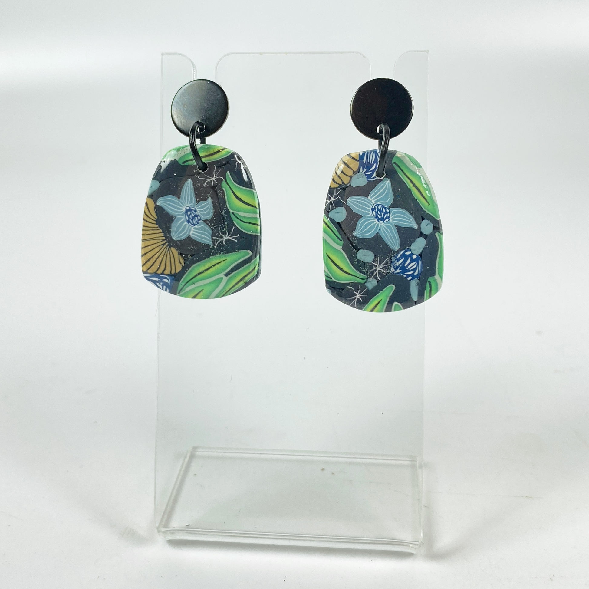 Blue Blossom Handmade Polymer Clay Earrrings on a small acrylic display stand
