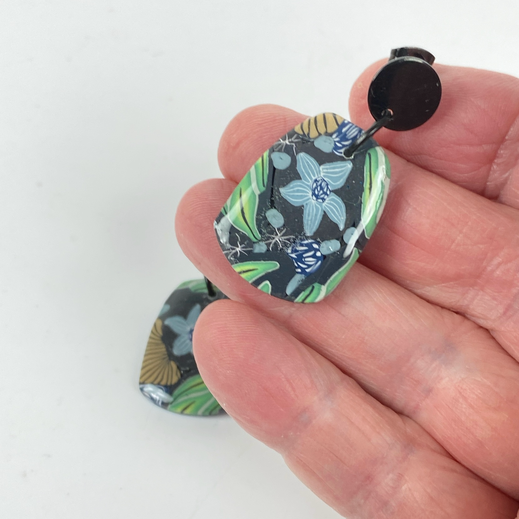Blue Blossom Handmade Polymer Clay Earrrings hand held for size reference
