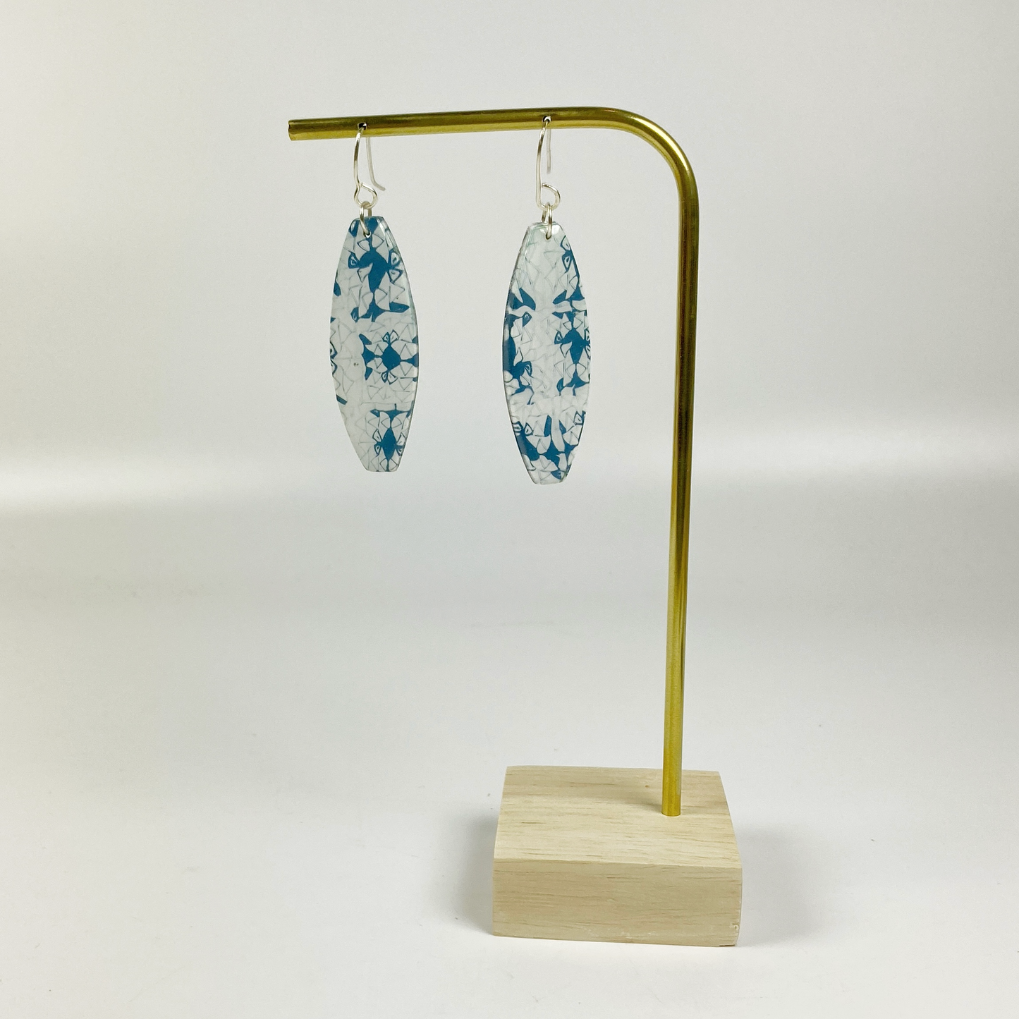 Denim Chic Handmade Polymer Clay Dangle Earrings on a brass display stand