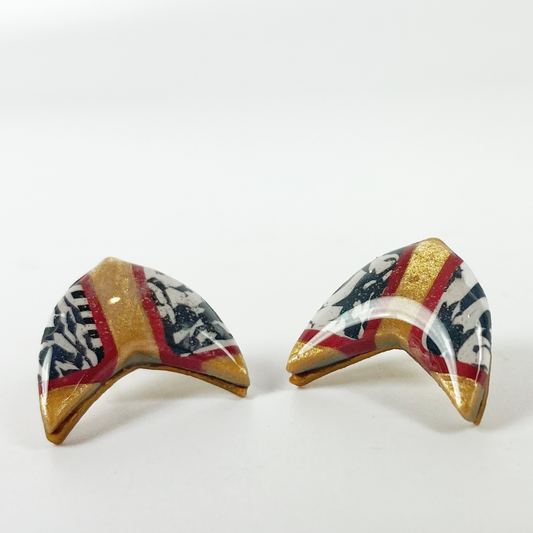 Red and Gold Handmade Polymer Clay Boomerang Stud Earrings white background.