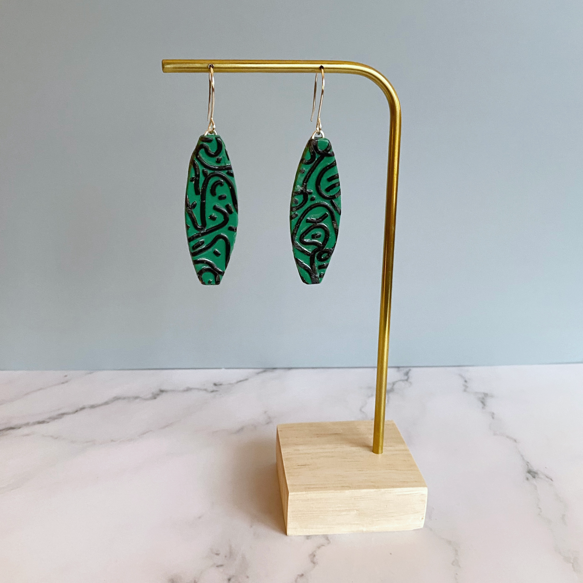 Green Graffiti Handmade Polymer Clay Dangle Earrings on brass earring display stand