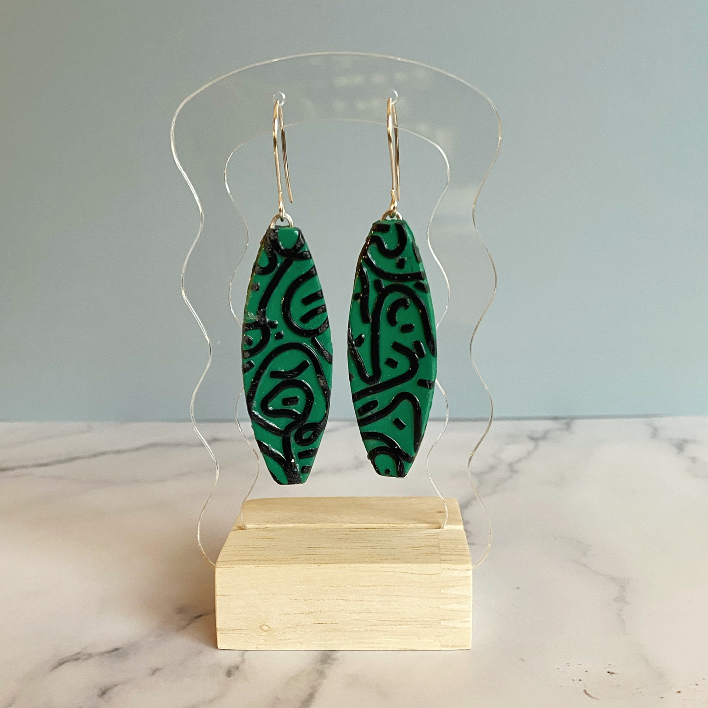 Green Graffiti Handmade Polymer Clay Dangle Earrings on acrylic display stand