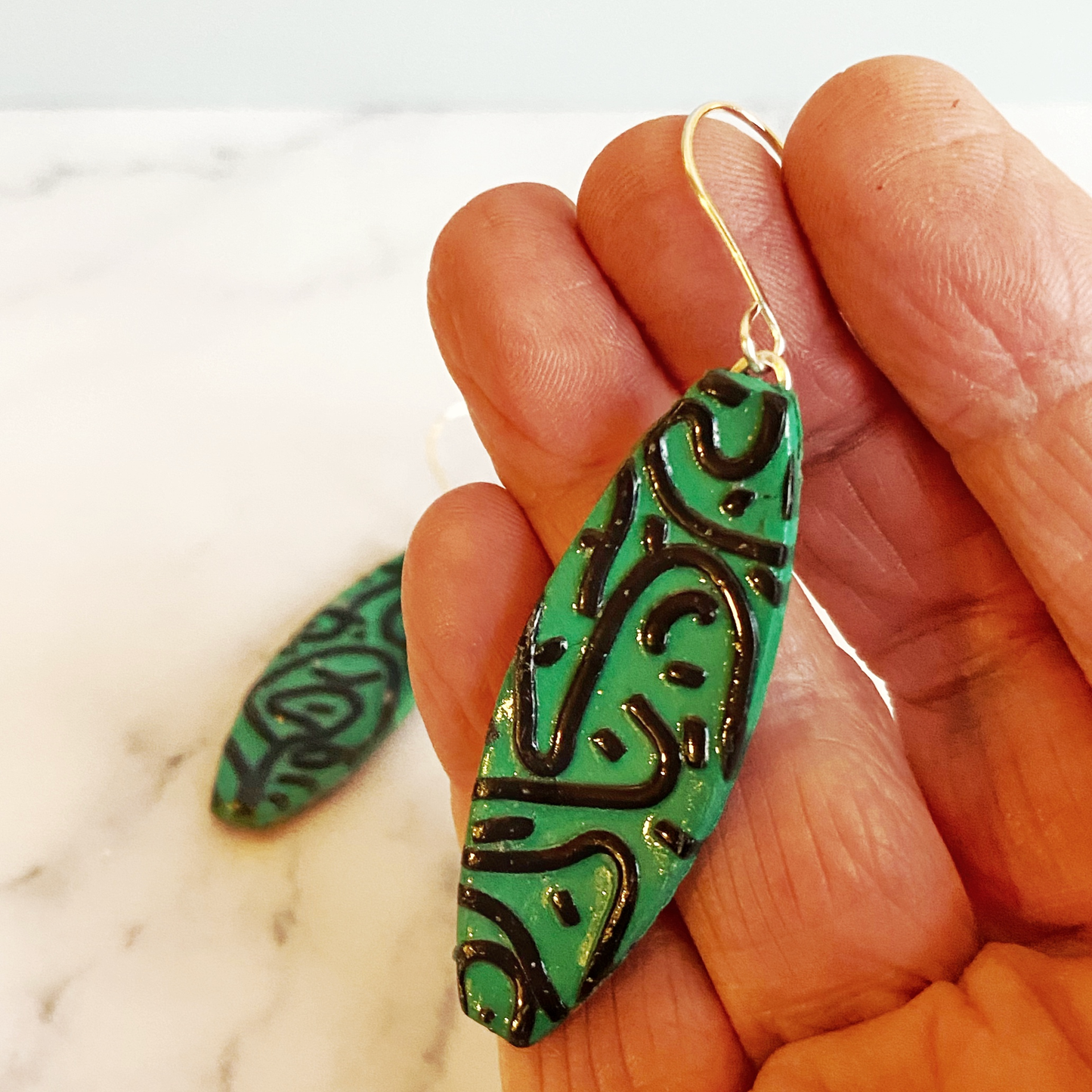 Green Graffiti Handmade Polymer Clay Dangle Earrings handheld for size reference