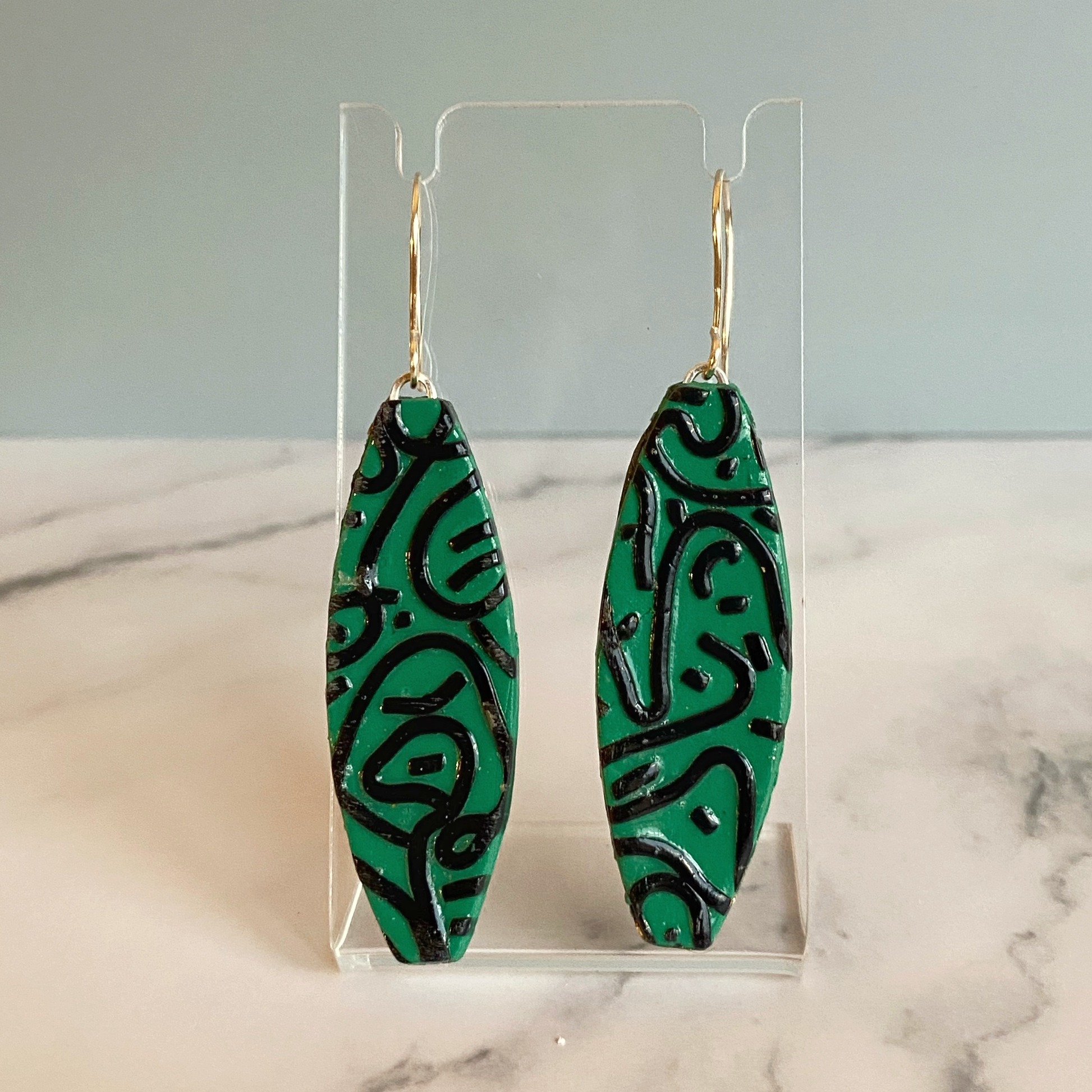 Green Graffiti Handmade Polymer Clay Dangle Earrings on earring display stand