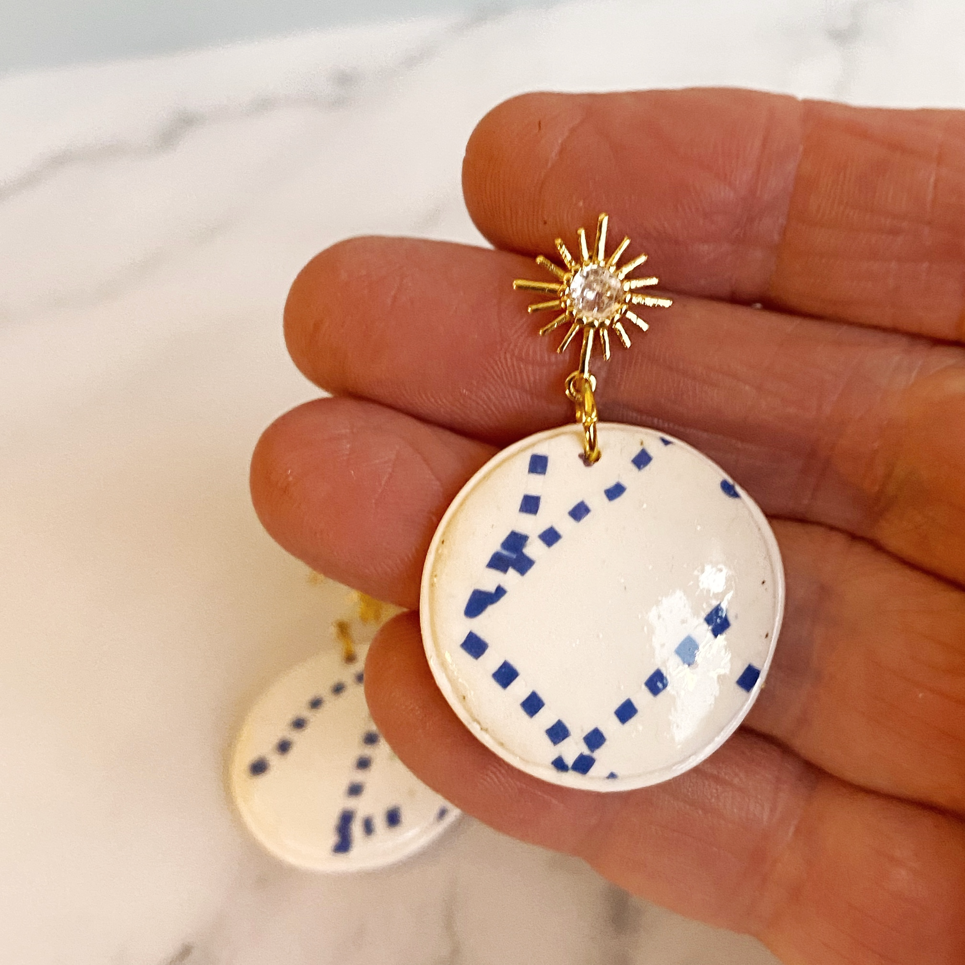 Blue and White Handmade Polymer Clay Dangle Earrings handheld for size reference
