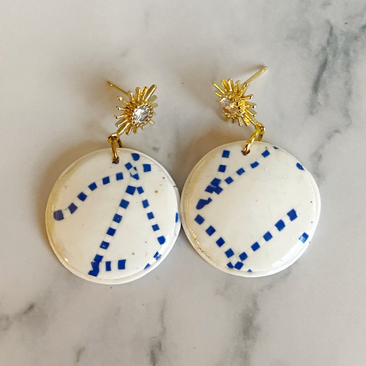 Blue and White Handmade Polymer Clay Dangle Earrings on a marble background