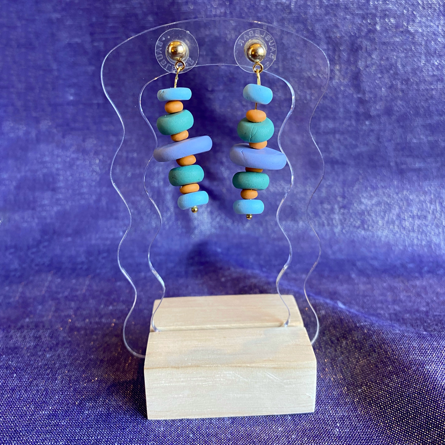 Polymer Clay Cairn Dangle Earrings Handmade on a transparent acrylic stand