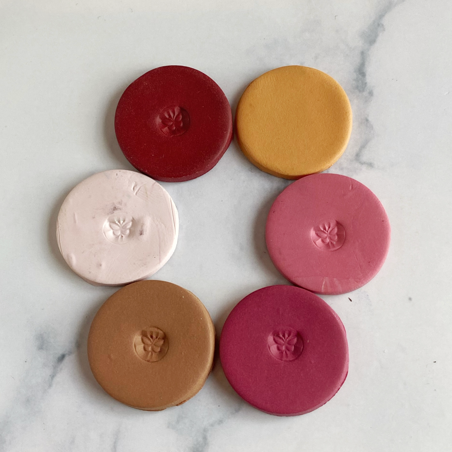 sample clay discs in the six colors of this palette laid out in a circle