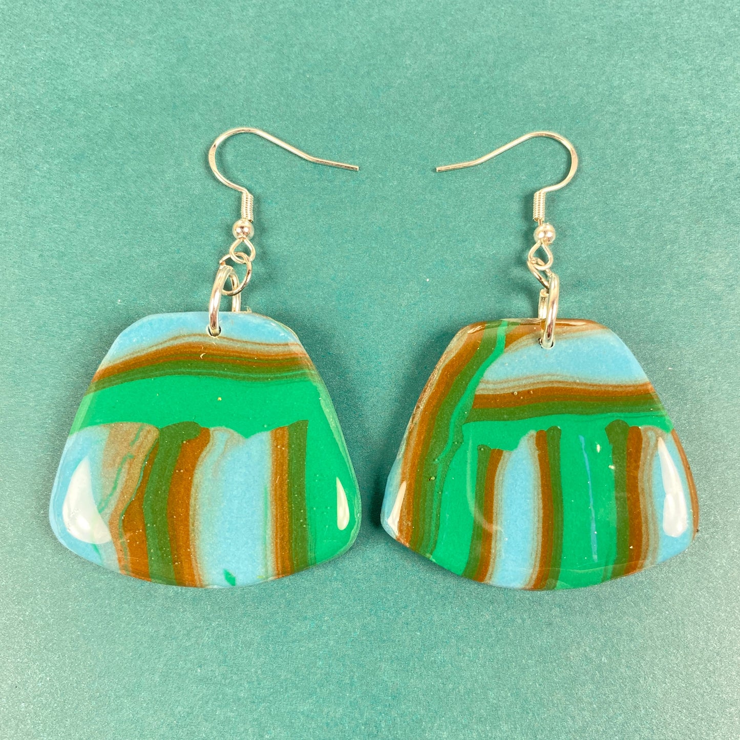 Hip Striped Handmade Polymer Clay Dangle Earrings on blue background