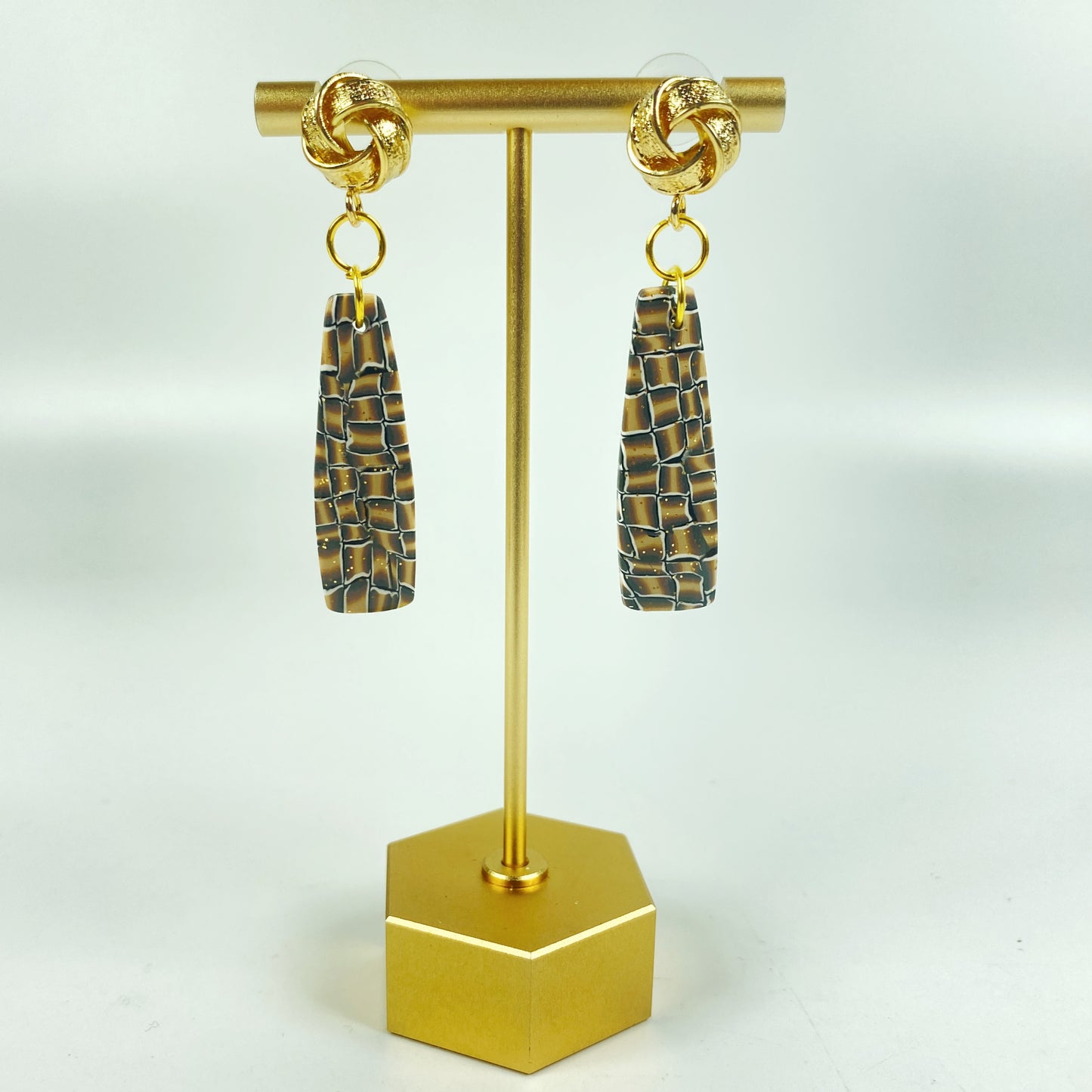 Golden Lattice Polymer Clay Handmade Dangle Earrings on a brass display stand
