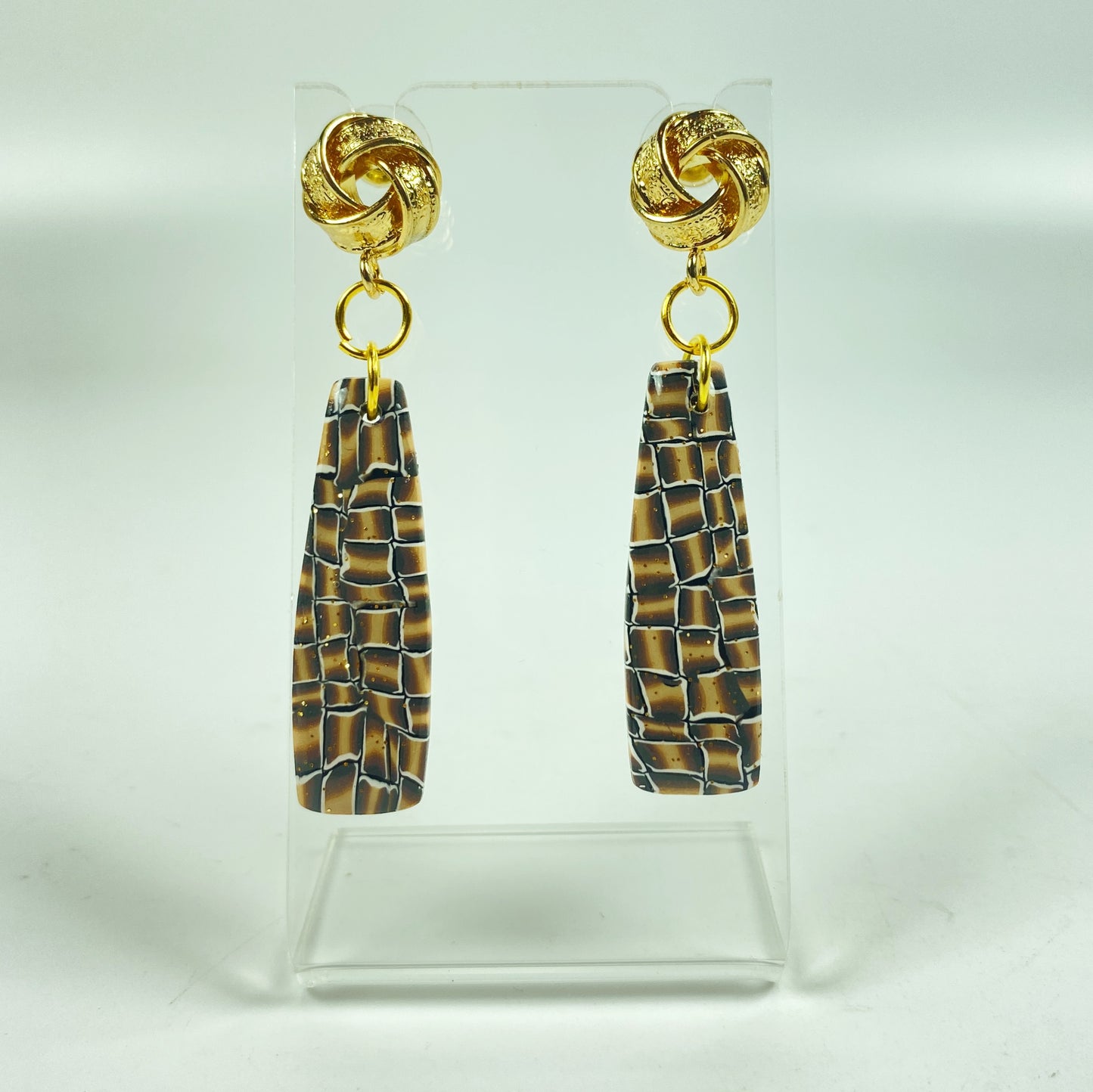 Golden Lattice Polymer Clay Handmade Dangle Earrings on a small acrylic display stand