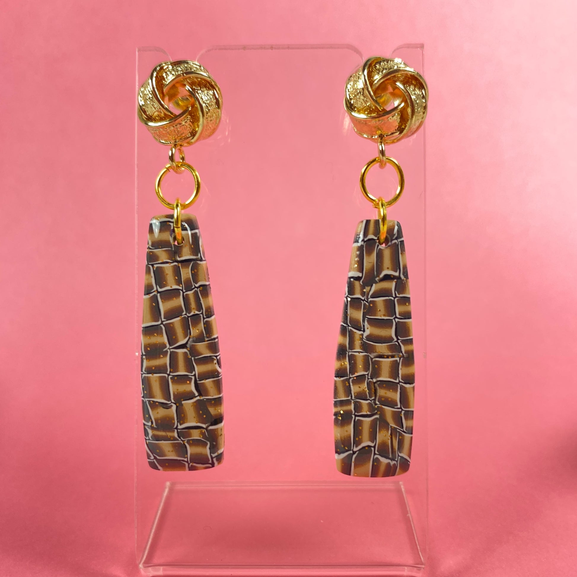 Golden Lattice Polymer Clay Handmade Dangle Earrings front view on pink background