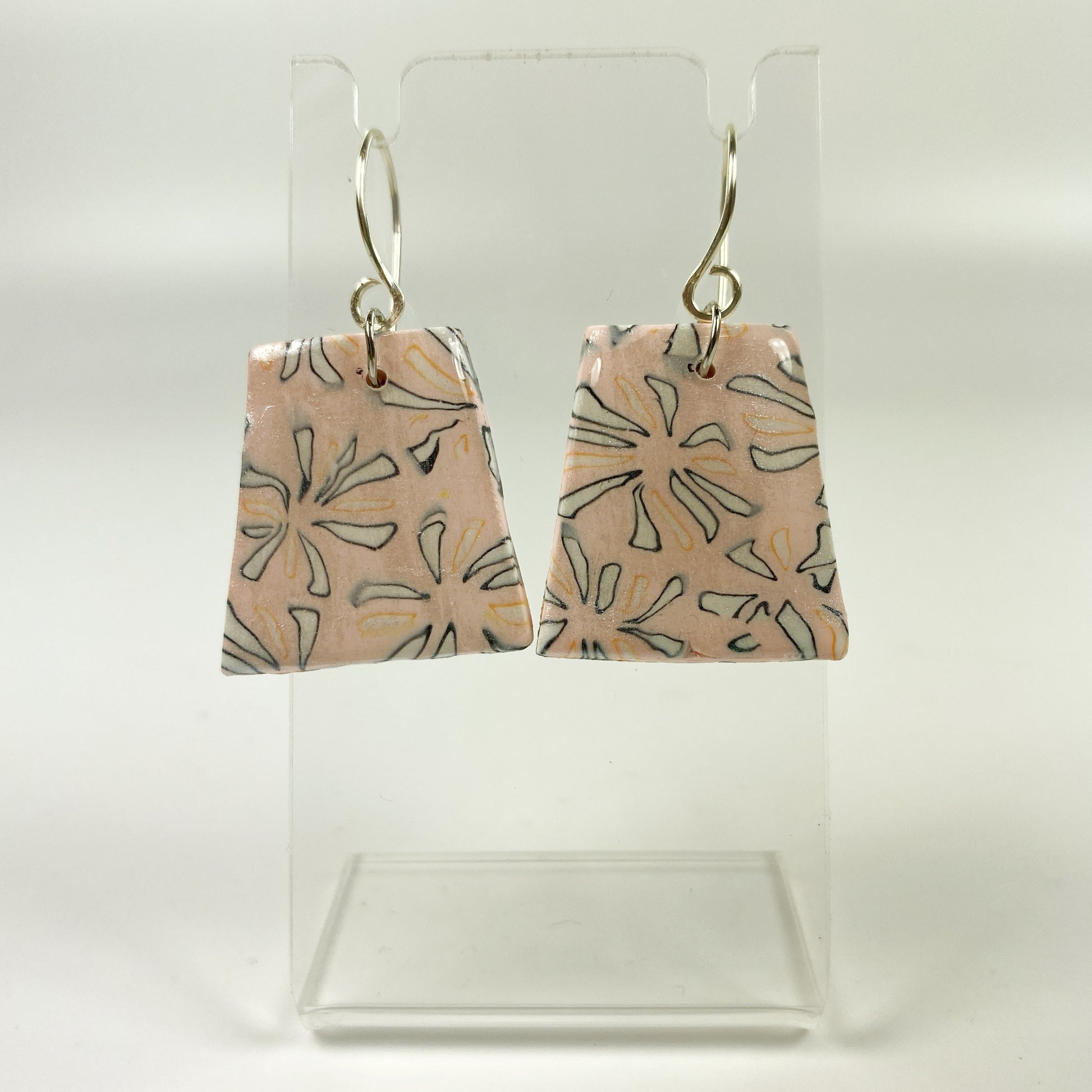 Polymer Clay Handmade Pink Dangle Earrings on a small acrylic earring display