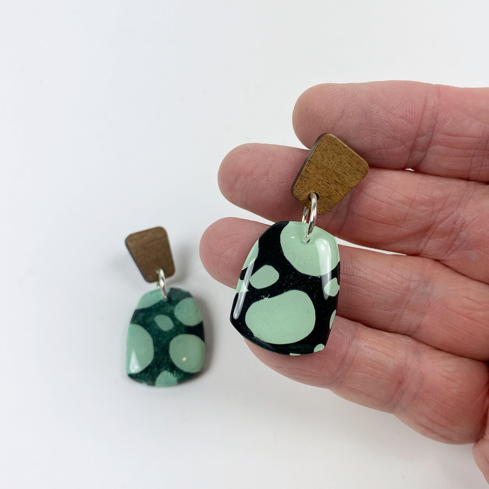 Midnight Forest Handmade Polymer Clay Dangle Earrings handheld for size reference