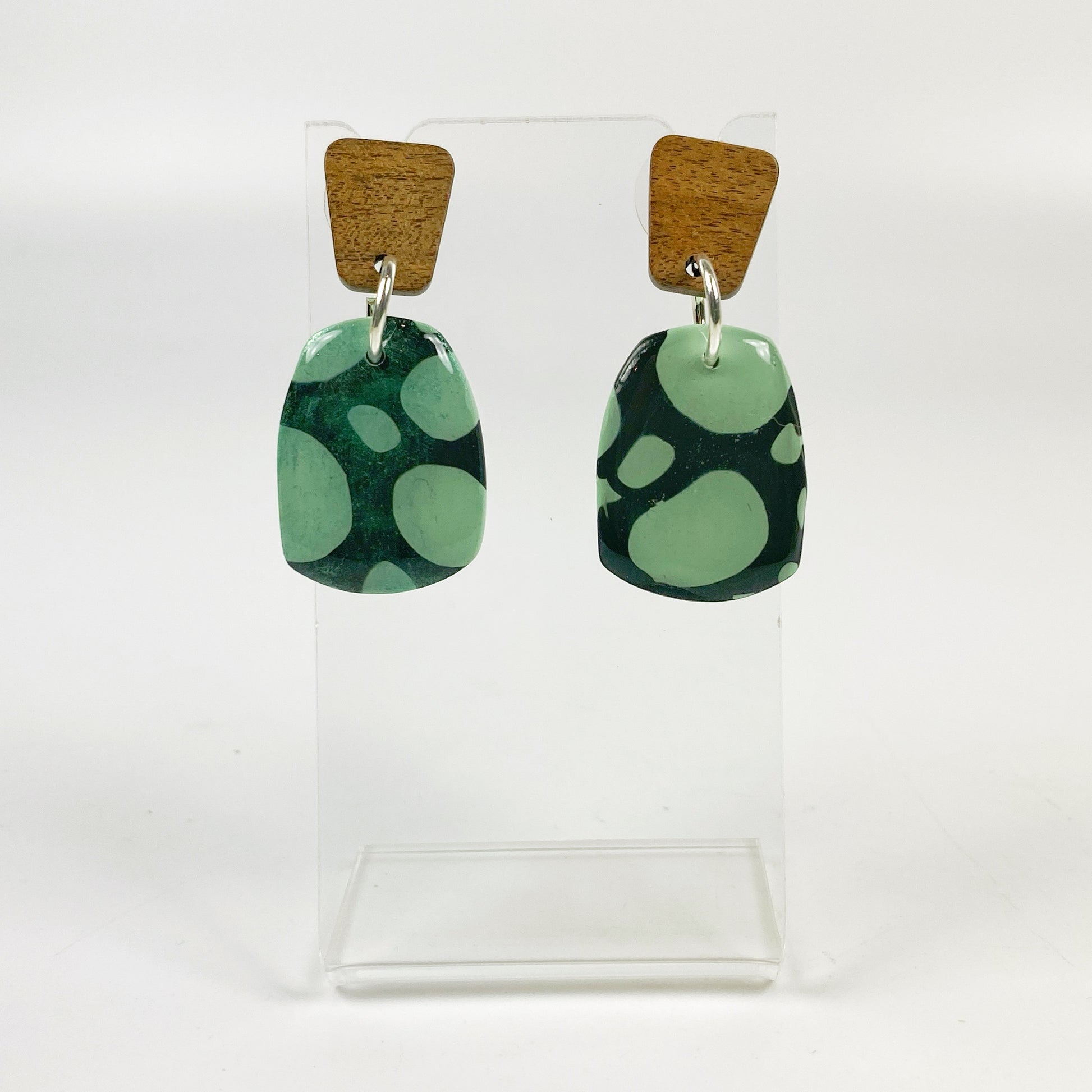 Midnight Forest Handmade Polymer Clay Dangle Earrings on an acrylic earring display stand